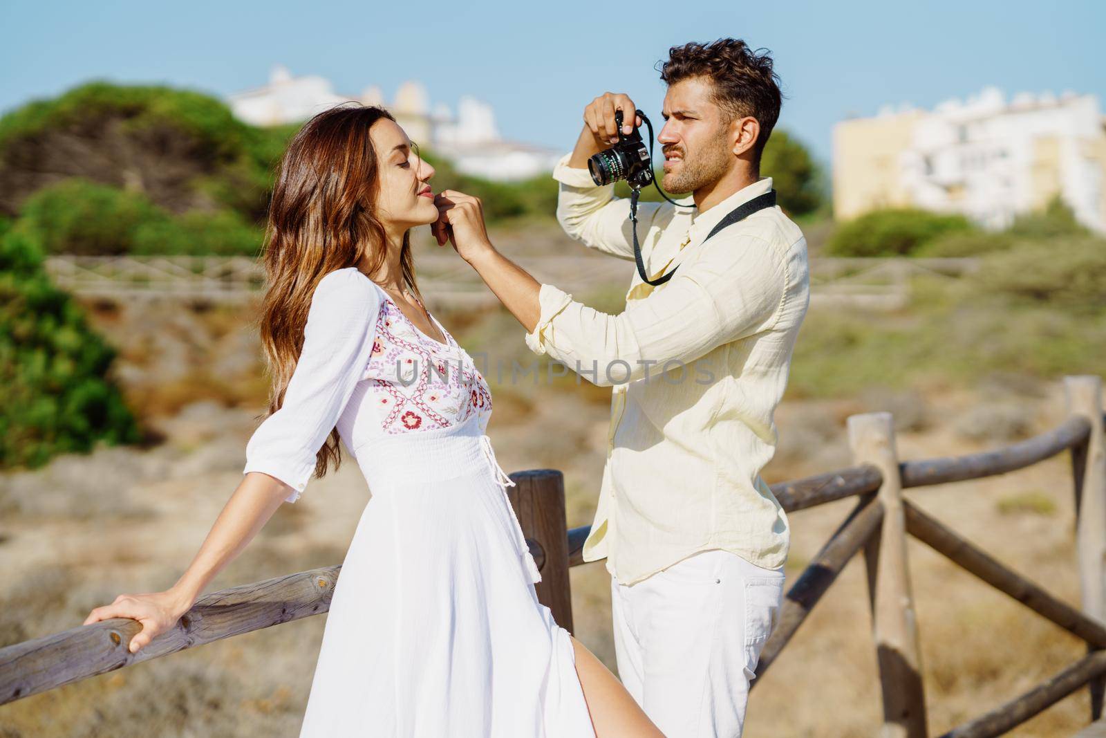 Man photographing his girlfriend on a lovers' trip Couple enjoying a natural environment.