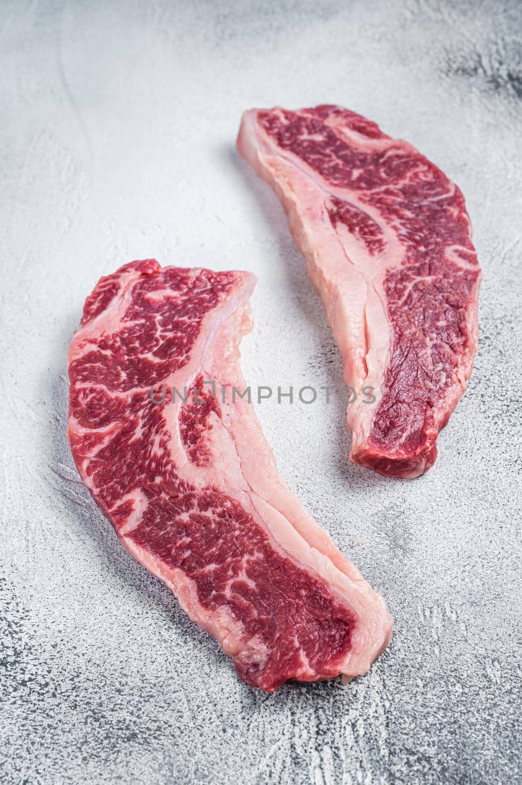 Striploin steak or New York steak, raw beef butchery meat cut. White background. Top view.