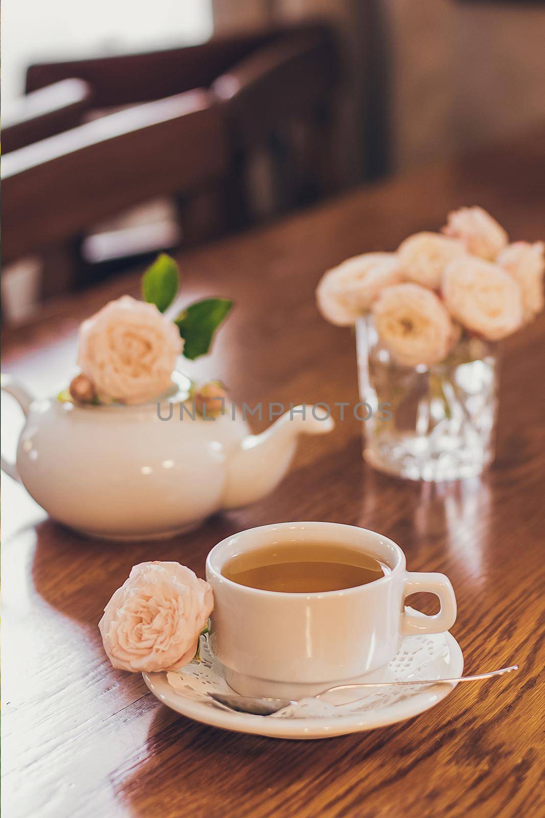 Beautiful fresh roses near a cup of tea and a in pastel tones romantic mood by mmp1206