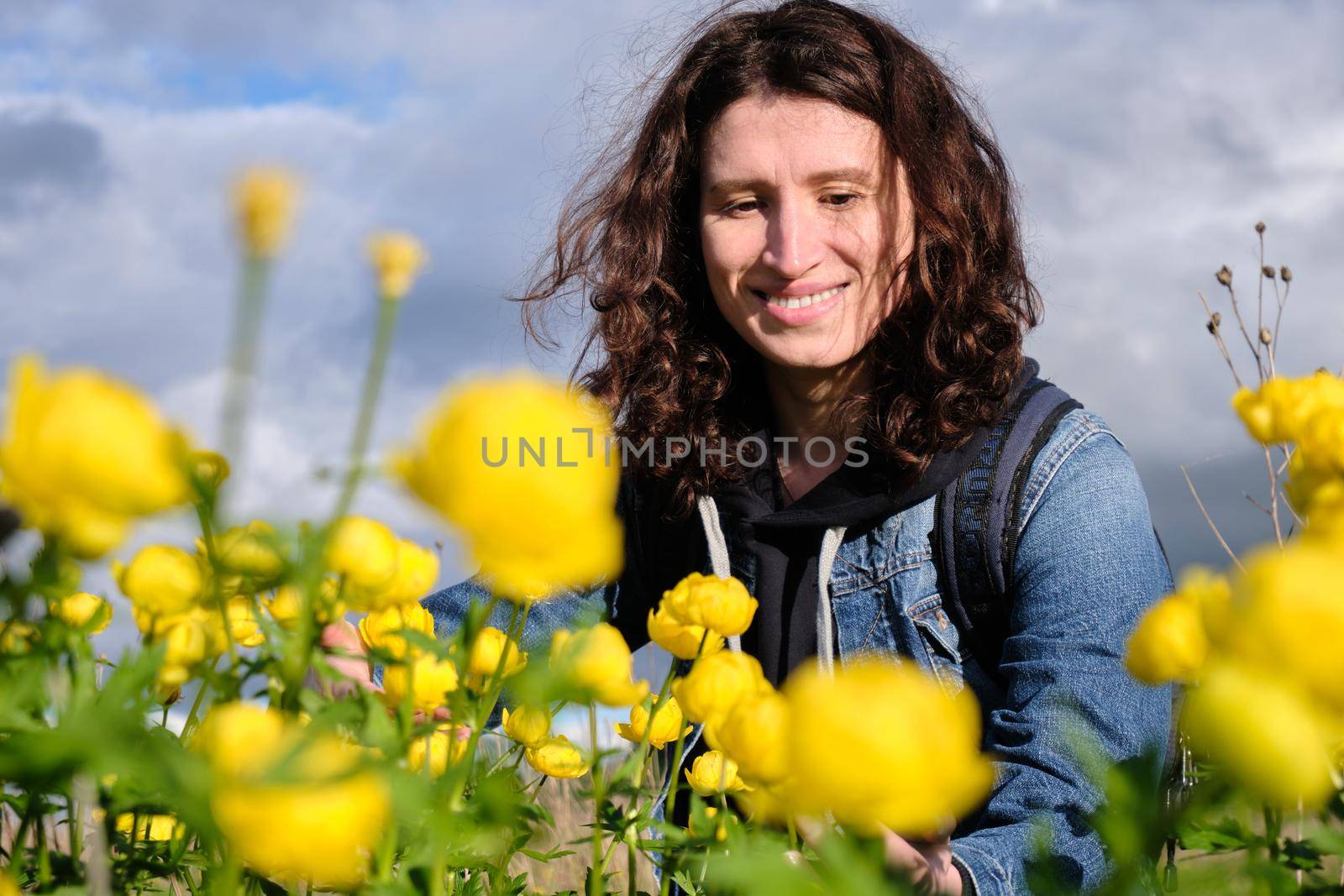Girl and yellow flowers. Travel outside the city. Wildlife. Summer time.