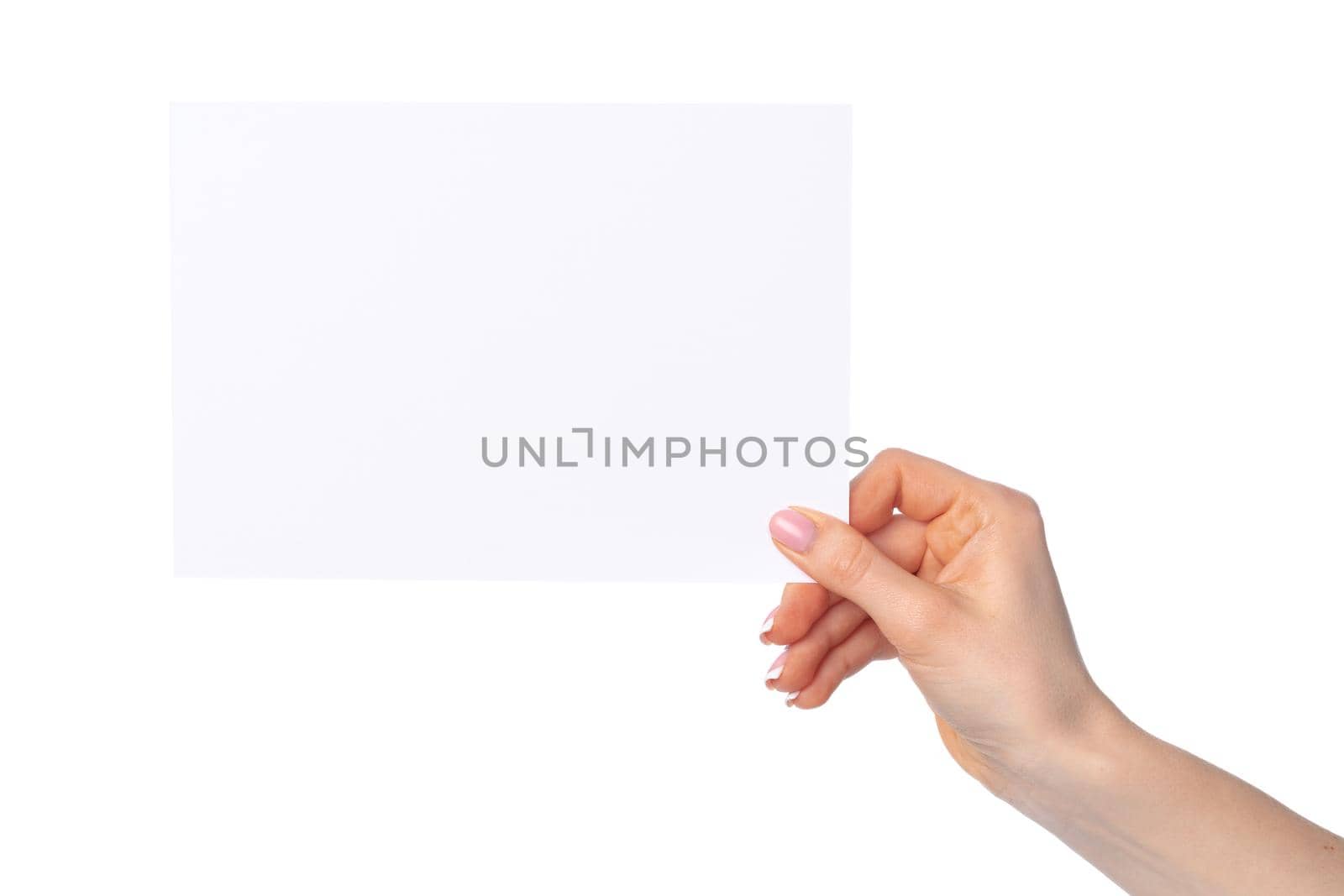 Woman's hand holding blank white sheet of paper isolated on white background