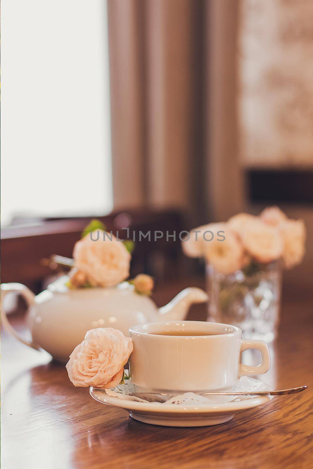 Beautiful fresh roses near a cup of tea and a in pastel tones romantic mood by mmp1206