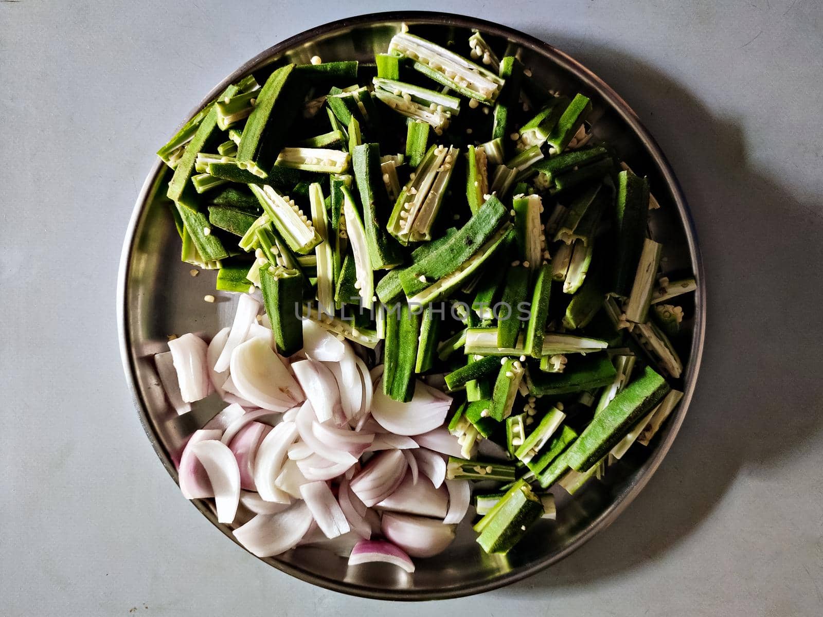 Freshly cut vegetables arranged in a plate for dinning preparations in home. by lalam