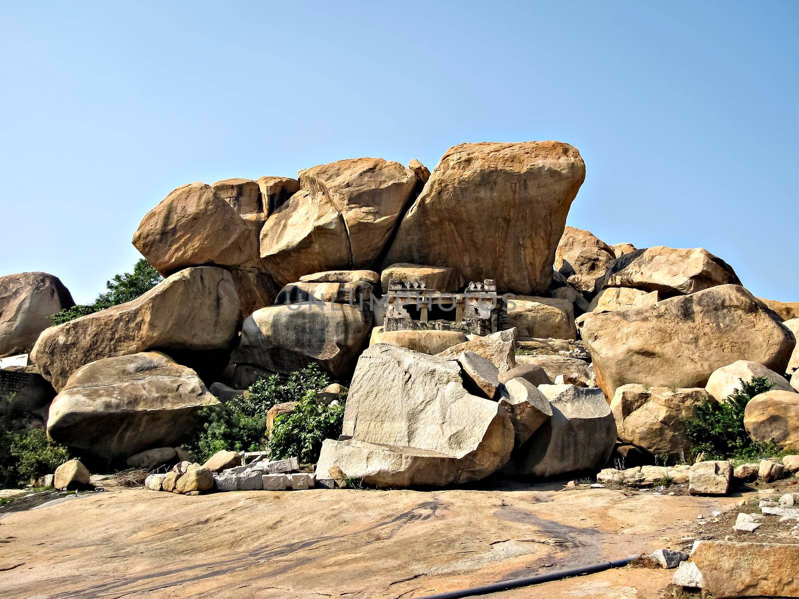 Ancient stone temples in solid rocks on hill in Hampi, Karnataka, India.