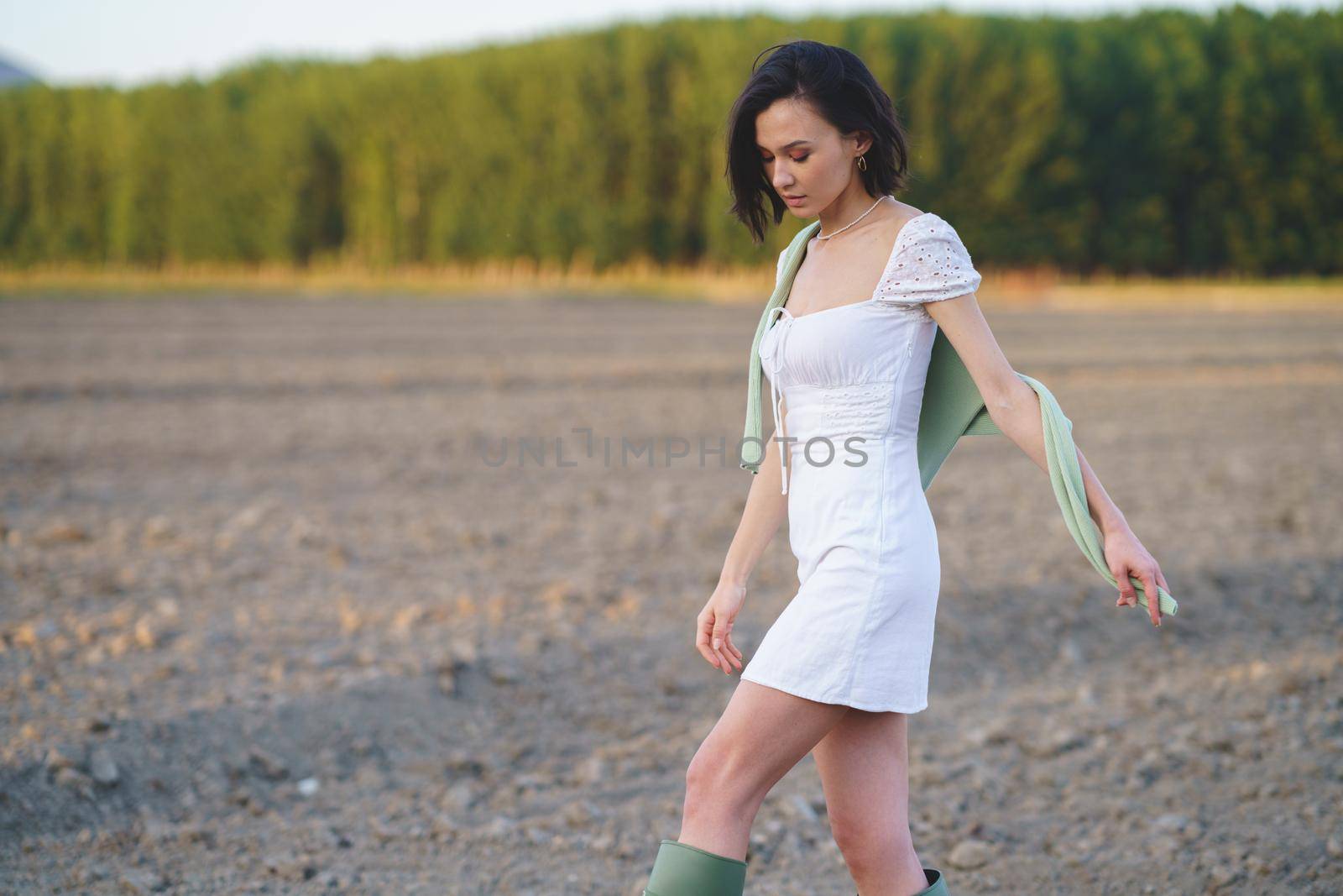 Asian woman, walking in the countryside, wearing a white dress. by javiindy