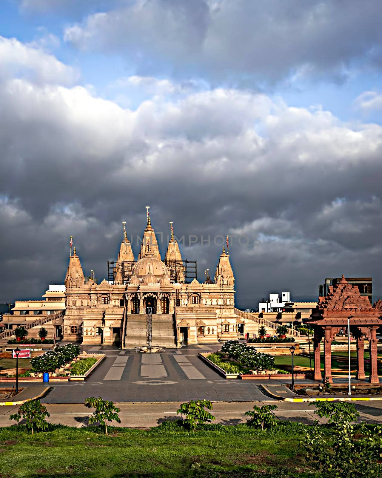 Crowdless Swaminarayan temple on a clear sunny day with clouds background in Ambegaon, Pune, Maharashtra, India. by lalam