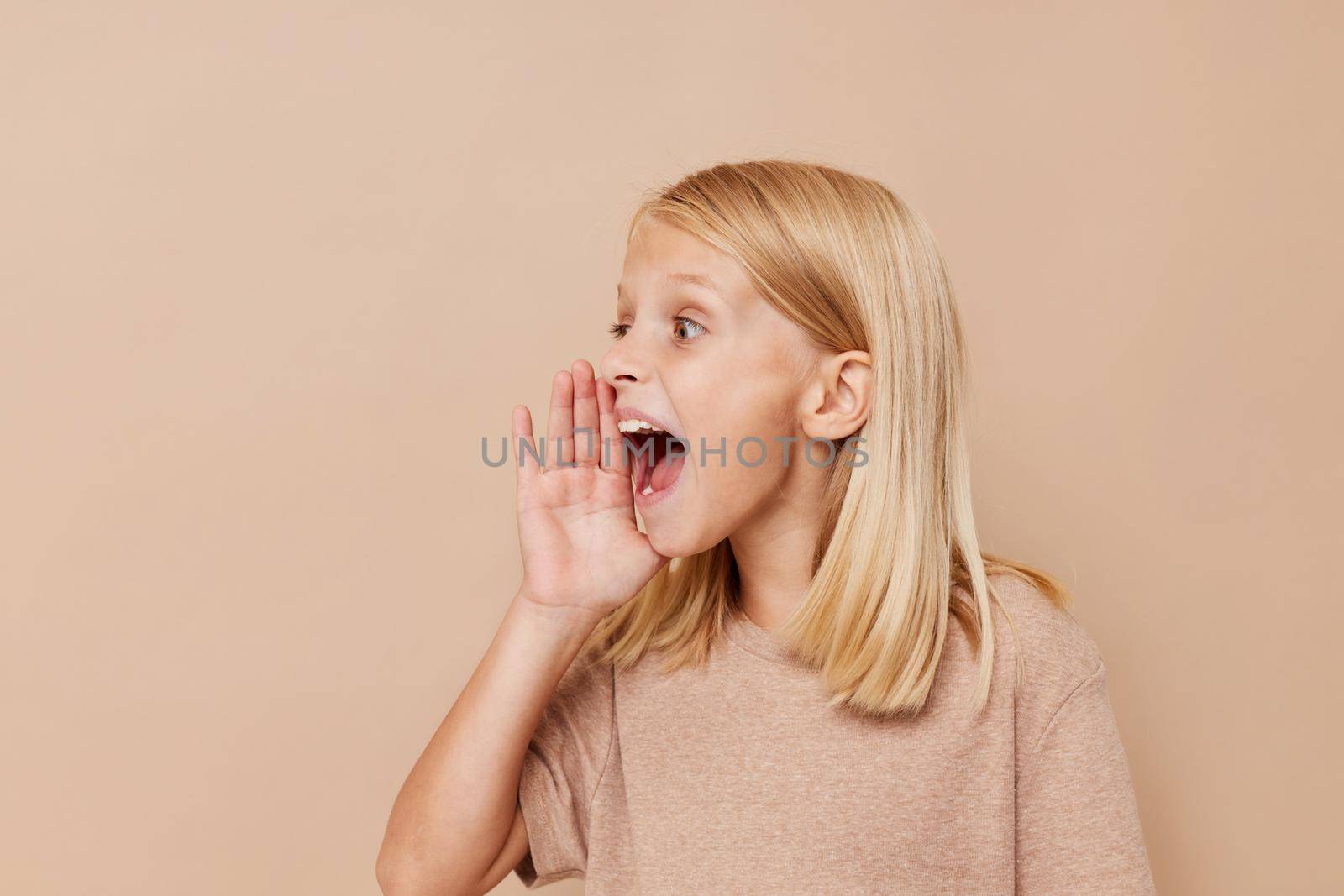 Little cute girl with blond hair posing studio by SHOTPRIME