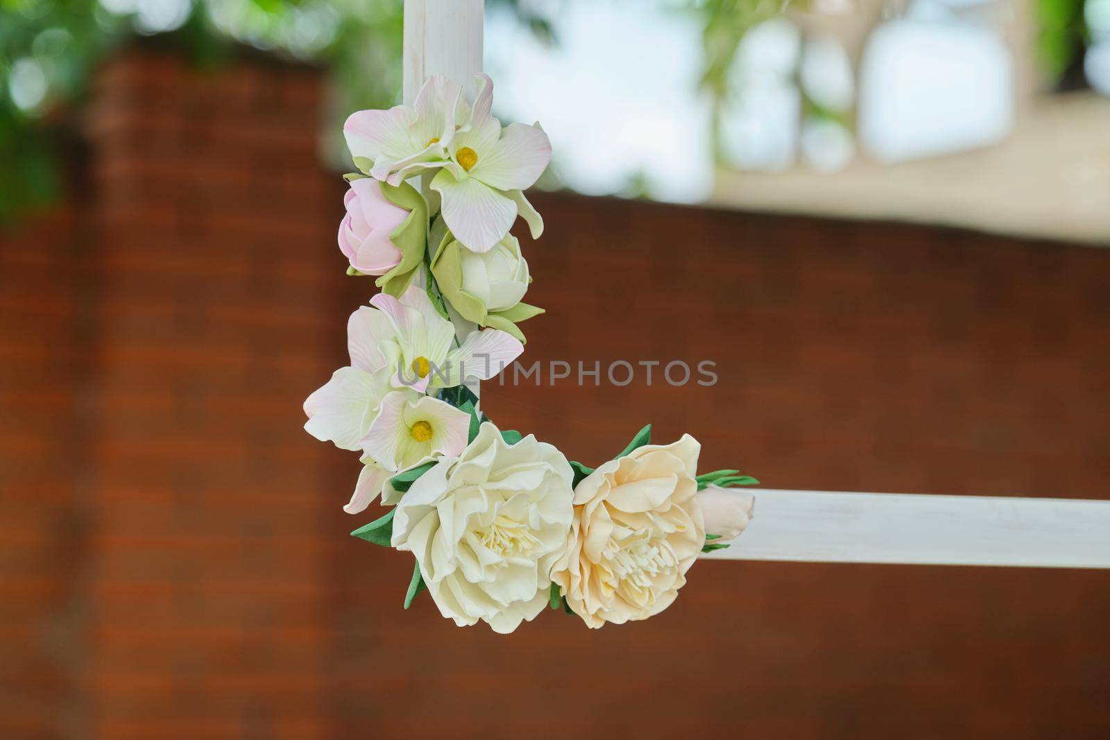 Wooden white frames decorated with flowers in the outdoor garden by VH-studio