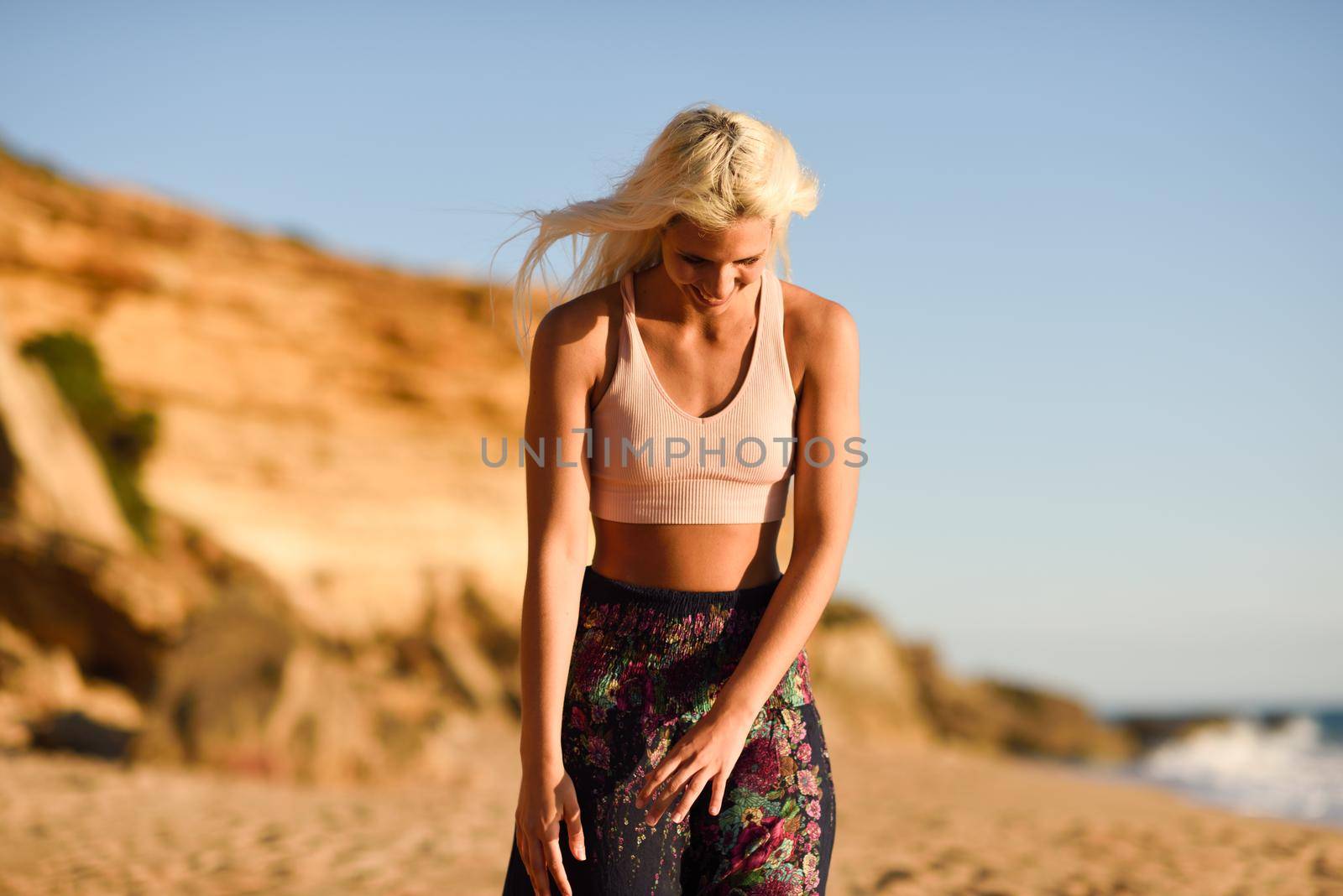 Woman enjoying the sunset on a beautiful beach in Cadiz, Andalusia, Spain.