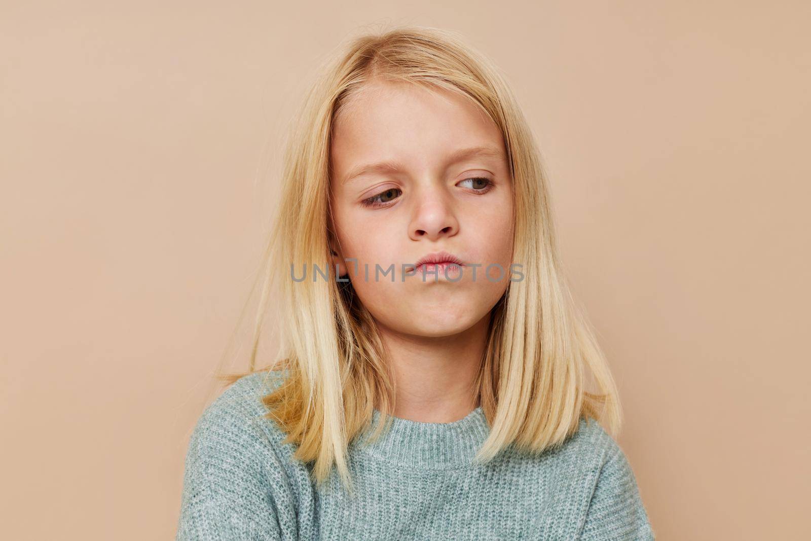 Beautiful little girl in a sweater, grimaces cropped view by SHOTPRIME