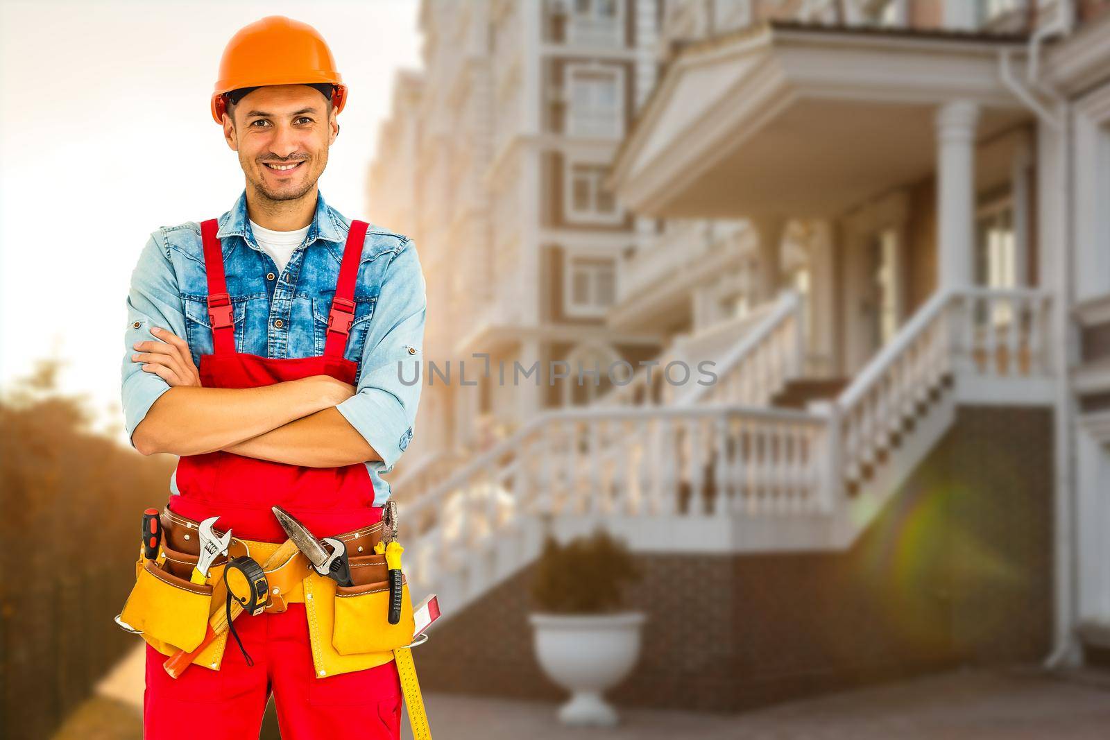 Smiling Construction worker man. Architecture background.
