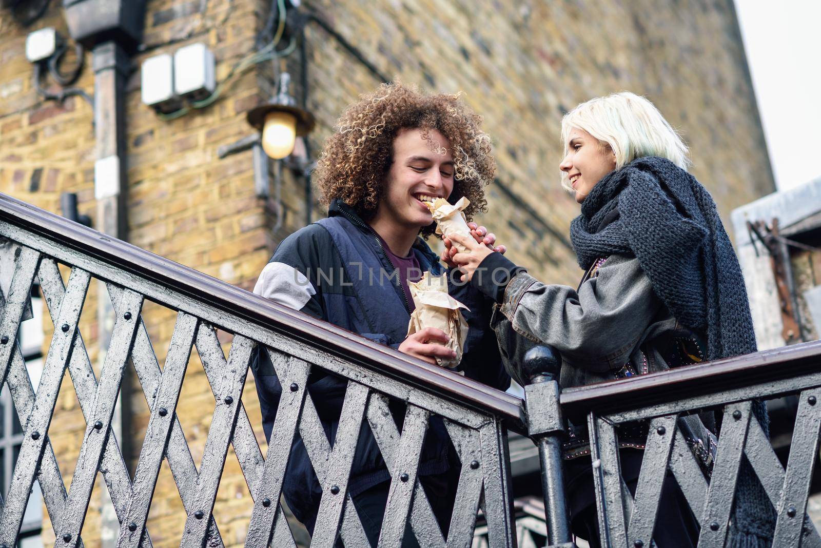 Happy couple eating Doner kebab, shawarma, in Camden Town, London. UK