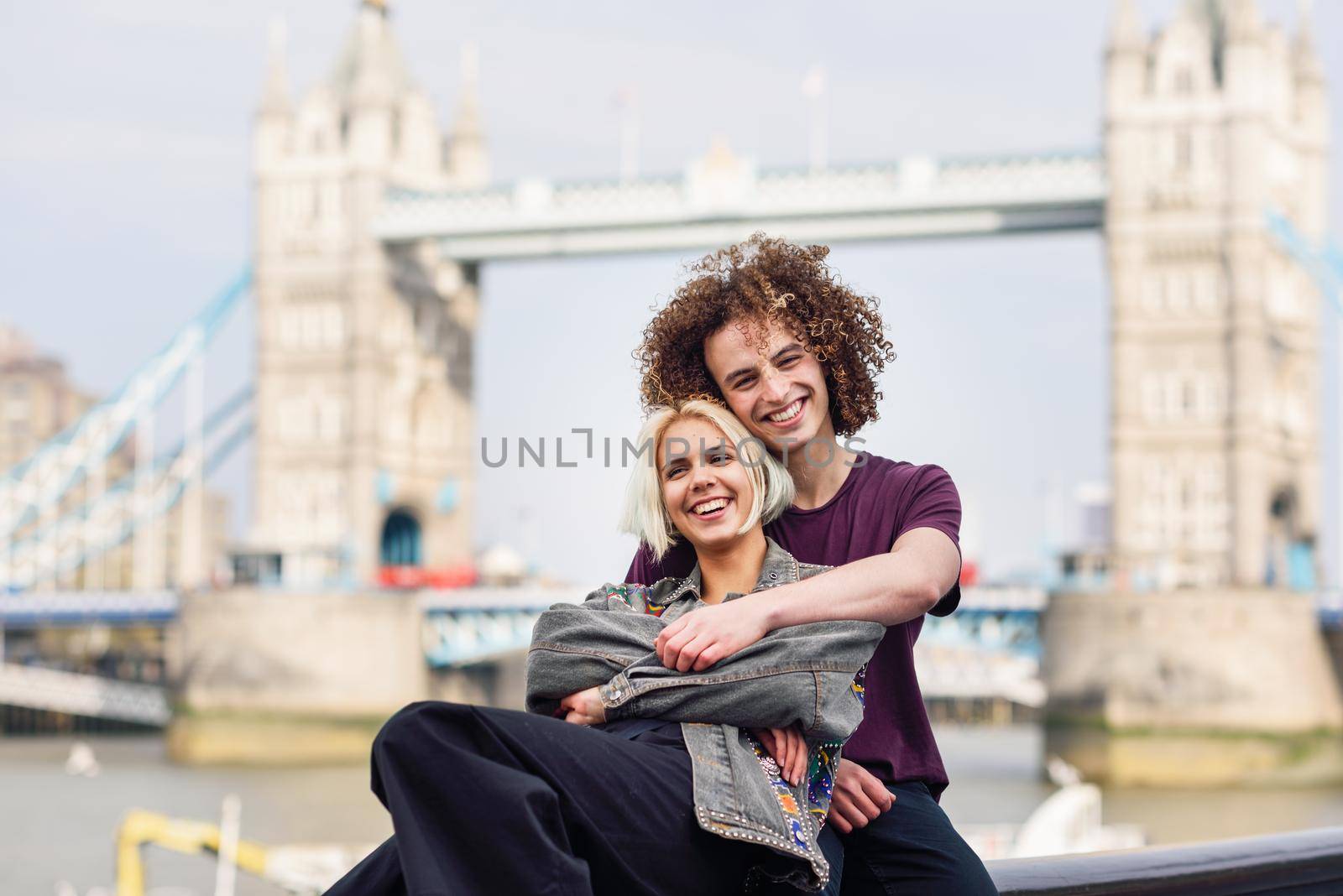 Happy couple hugging at the Tower Bridge, River Thames, London. UK