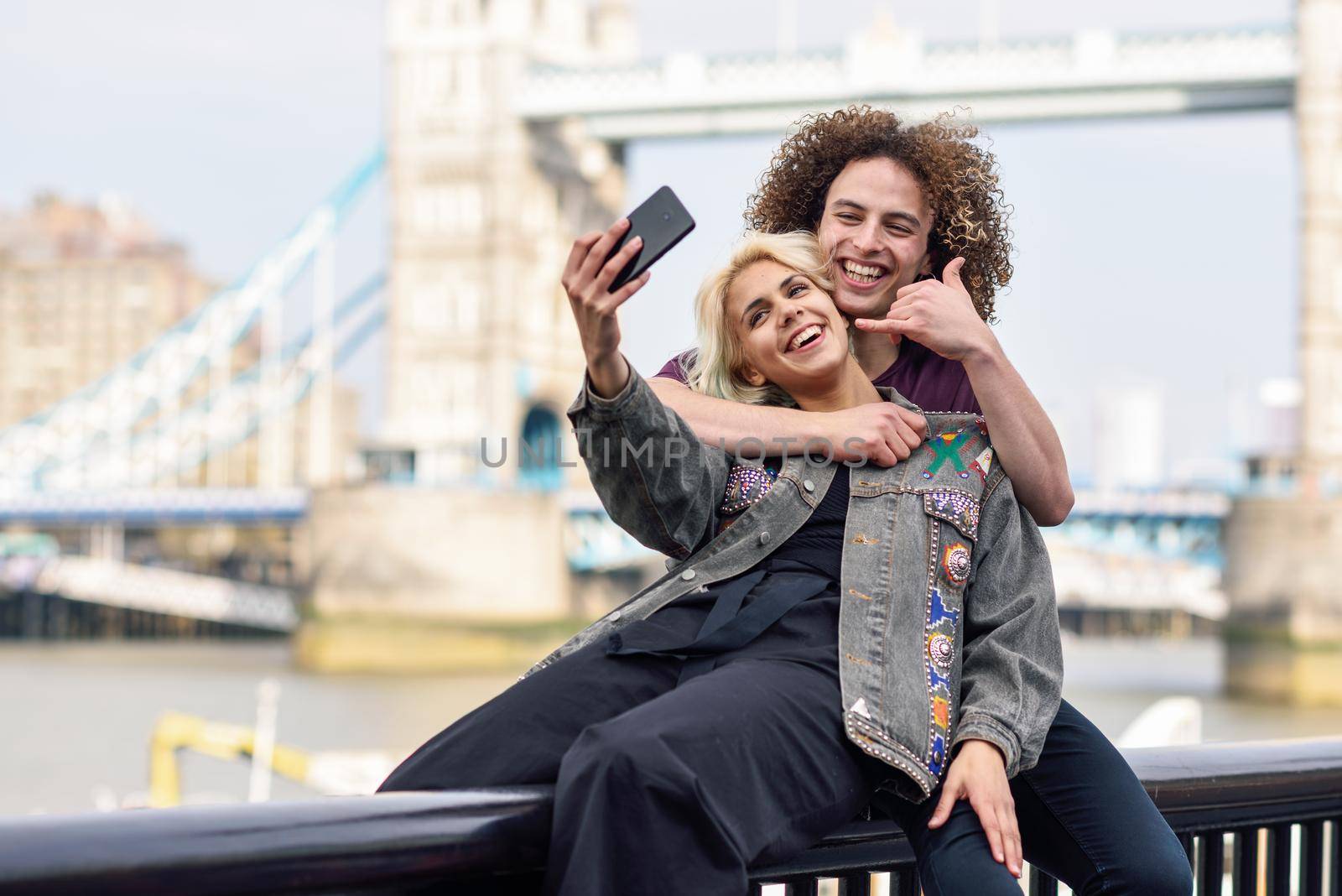 Young couple taking selfie photograph at the Tower Bridge, River Thames, London. UK
