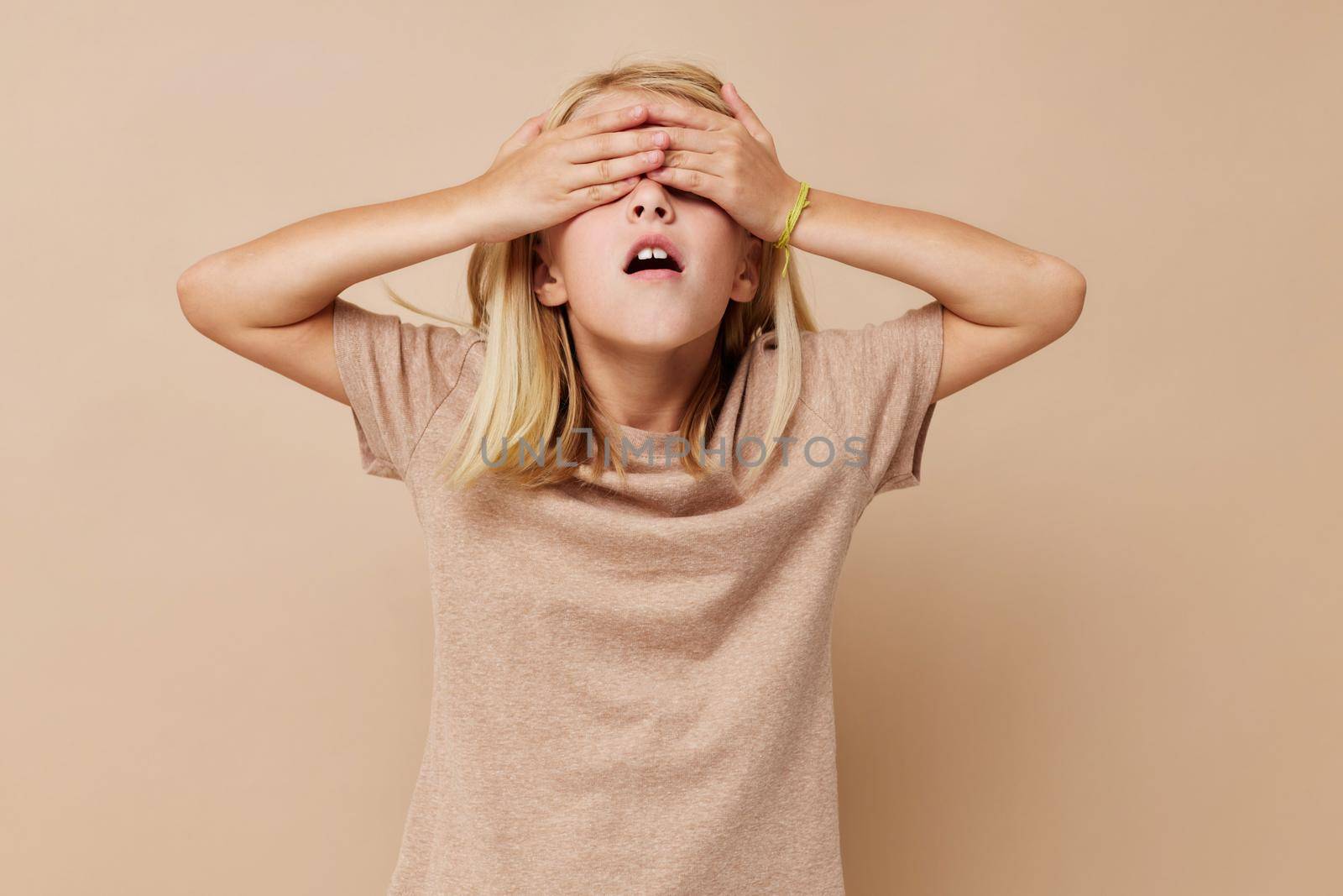 Portrait of a smiling little cutie in a beige t-shirt lifestyle concept by SHOTPRIME