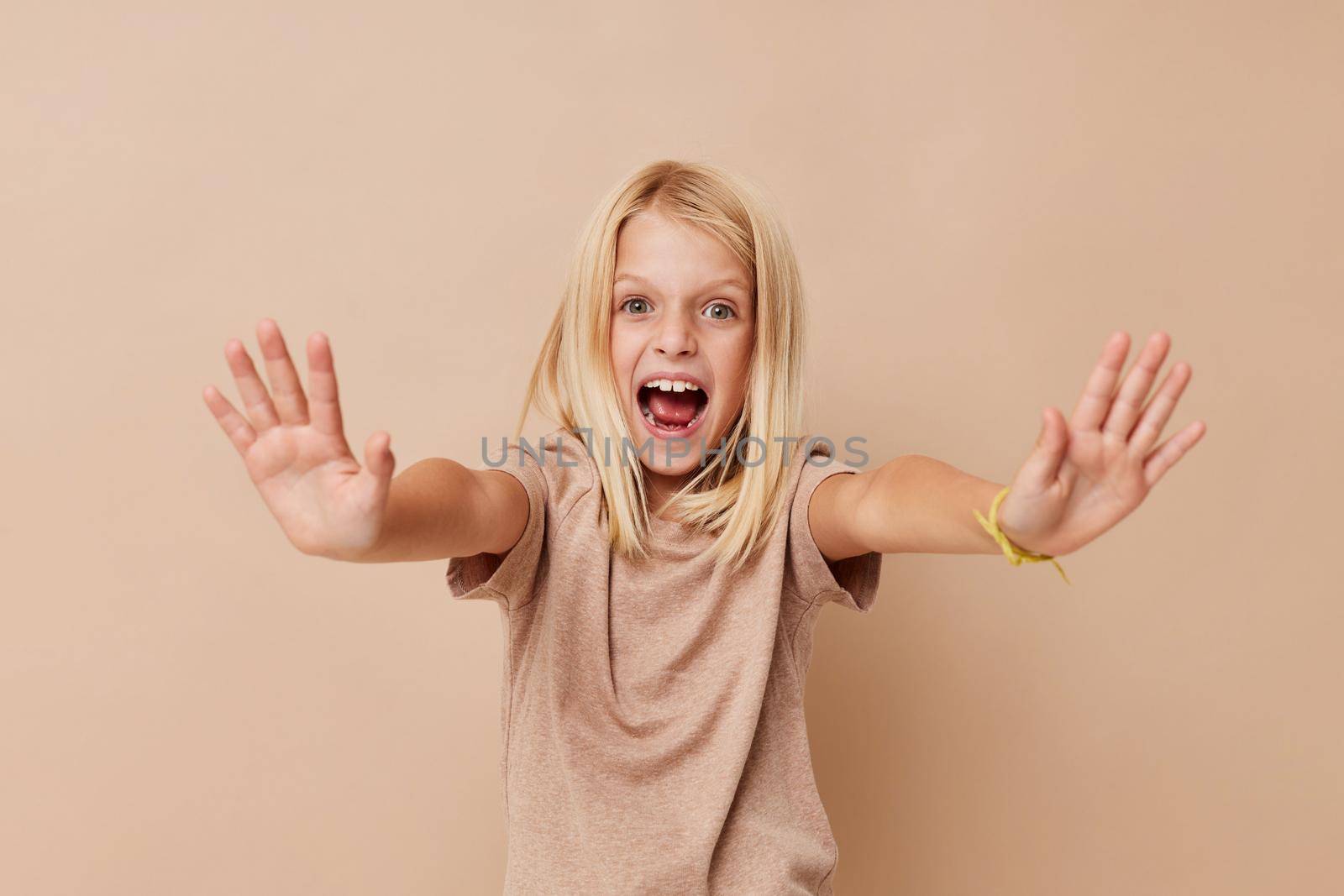 Little cute girl in a beige t-shirt lifestyle concept. High quality photo