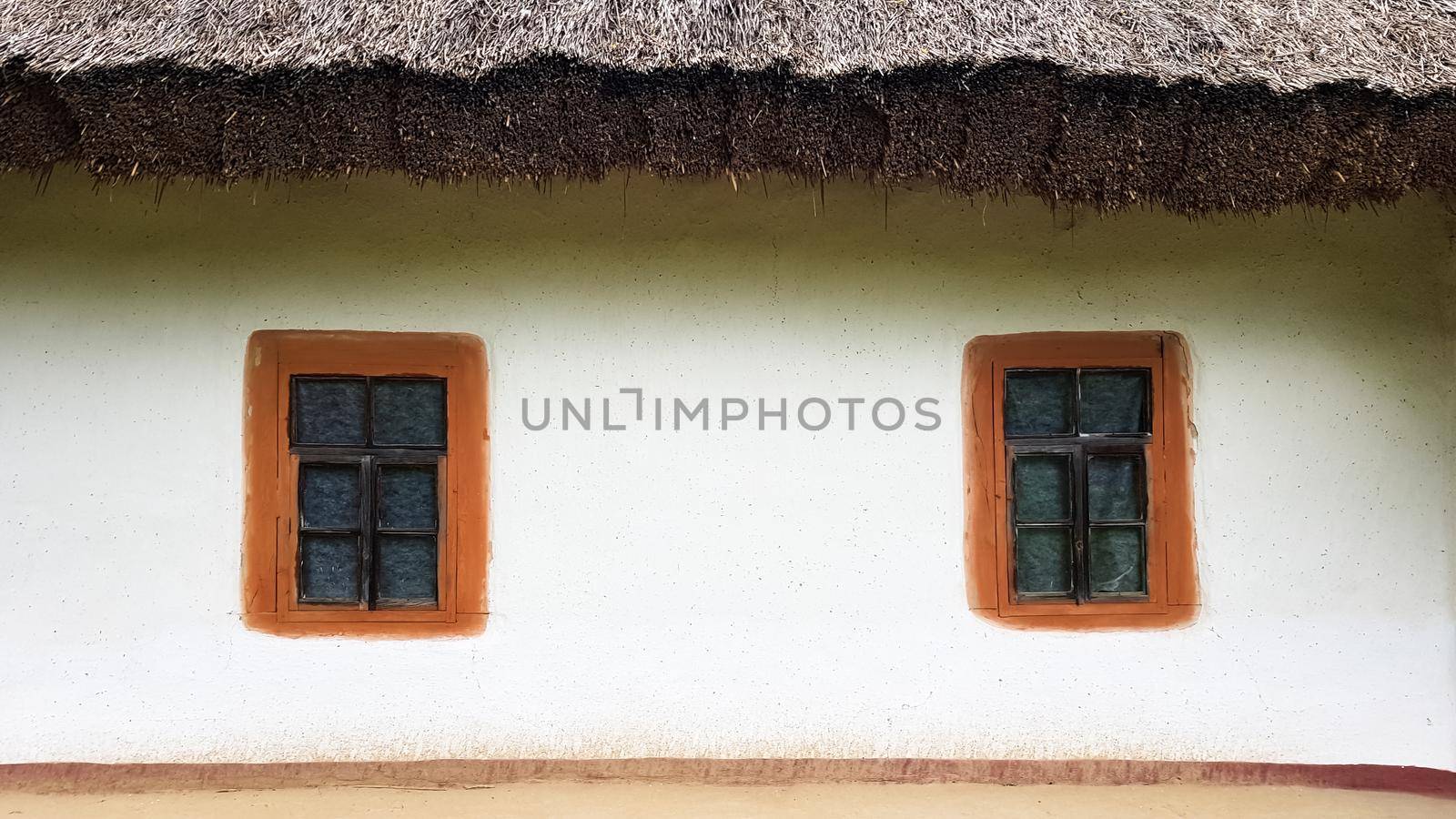 Ukraine, Kiev - June 11, 2020. Old window in a vintage traditional peasant house in Ukraine. Antique wooden window frame. Pirogovo National Museum in the open air in Kiev. Copy space