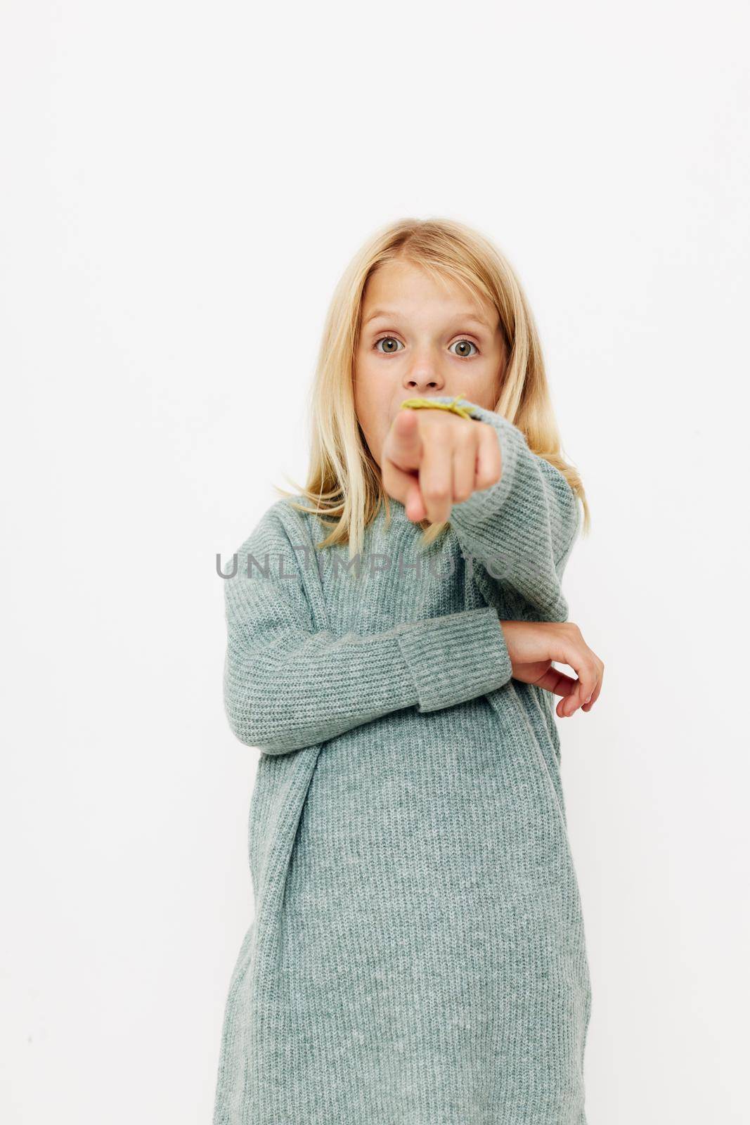 happy cute girl in a sweater, grimaces kids lifestyle concept. High quality photo