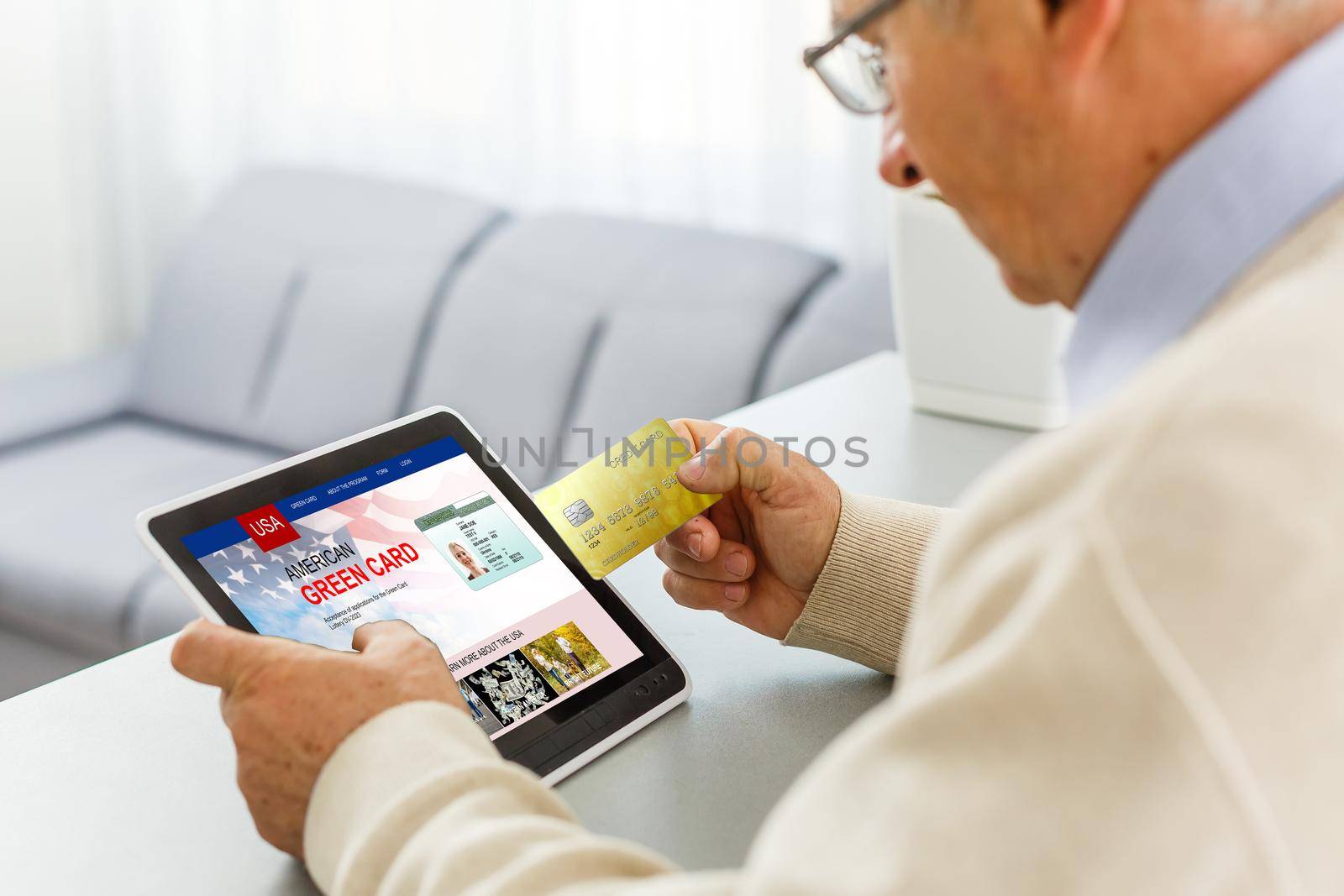 man with laptop with United States Permanent Resident Card website.