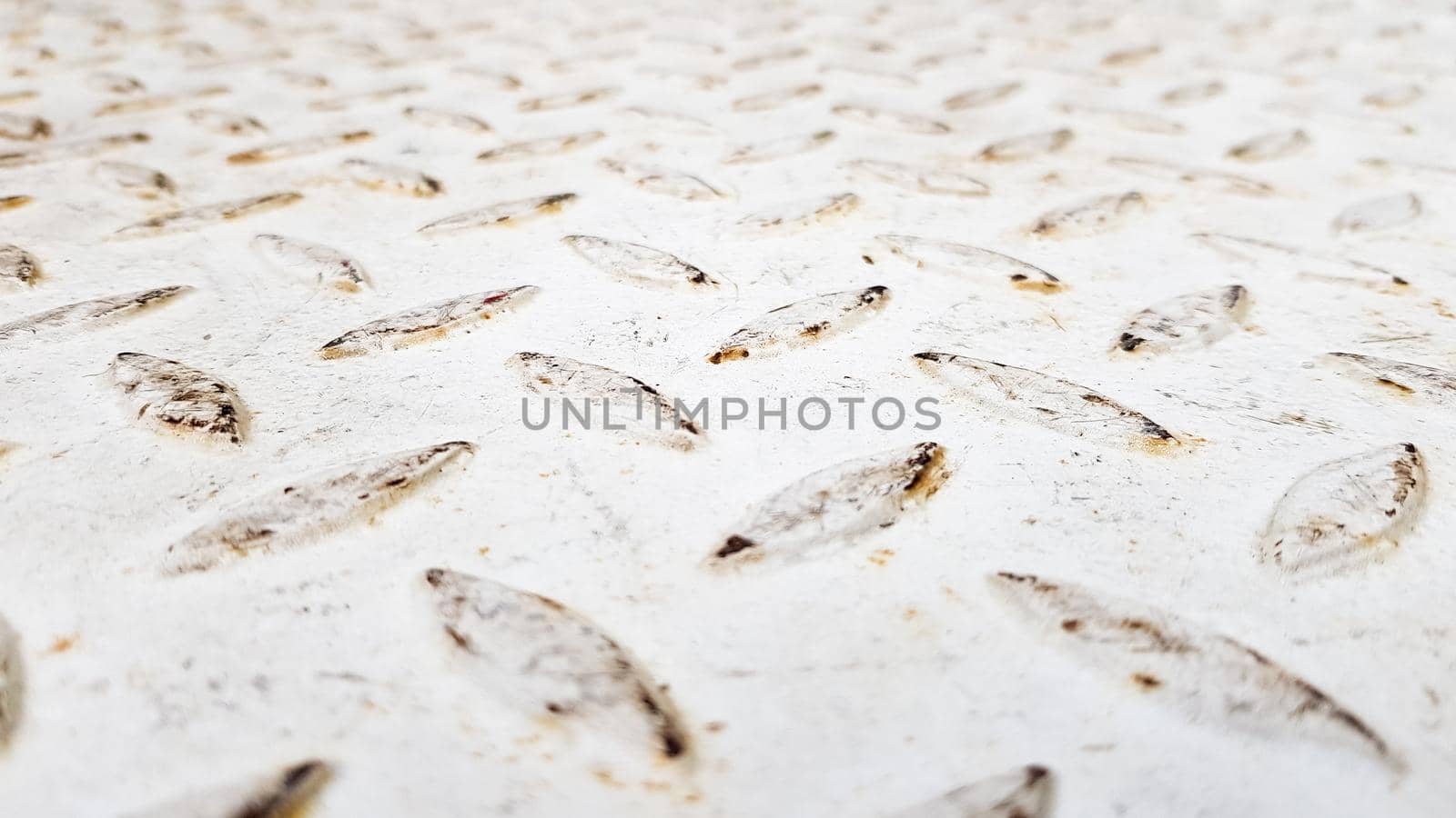 White steel sheet with embossed diamond pattern, used for floors and industrial building. White vintage steel plate useful as background.