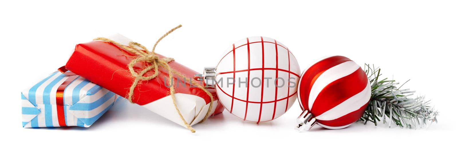 Christmas baubles and festive gift box isolated on white background, close up