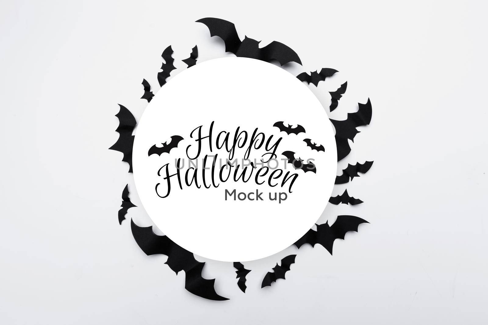 Halloween concept - black paper bats on white background