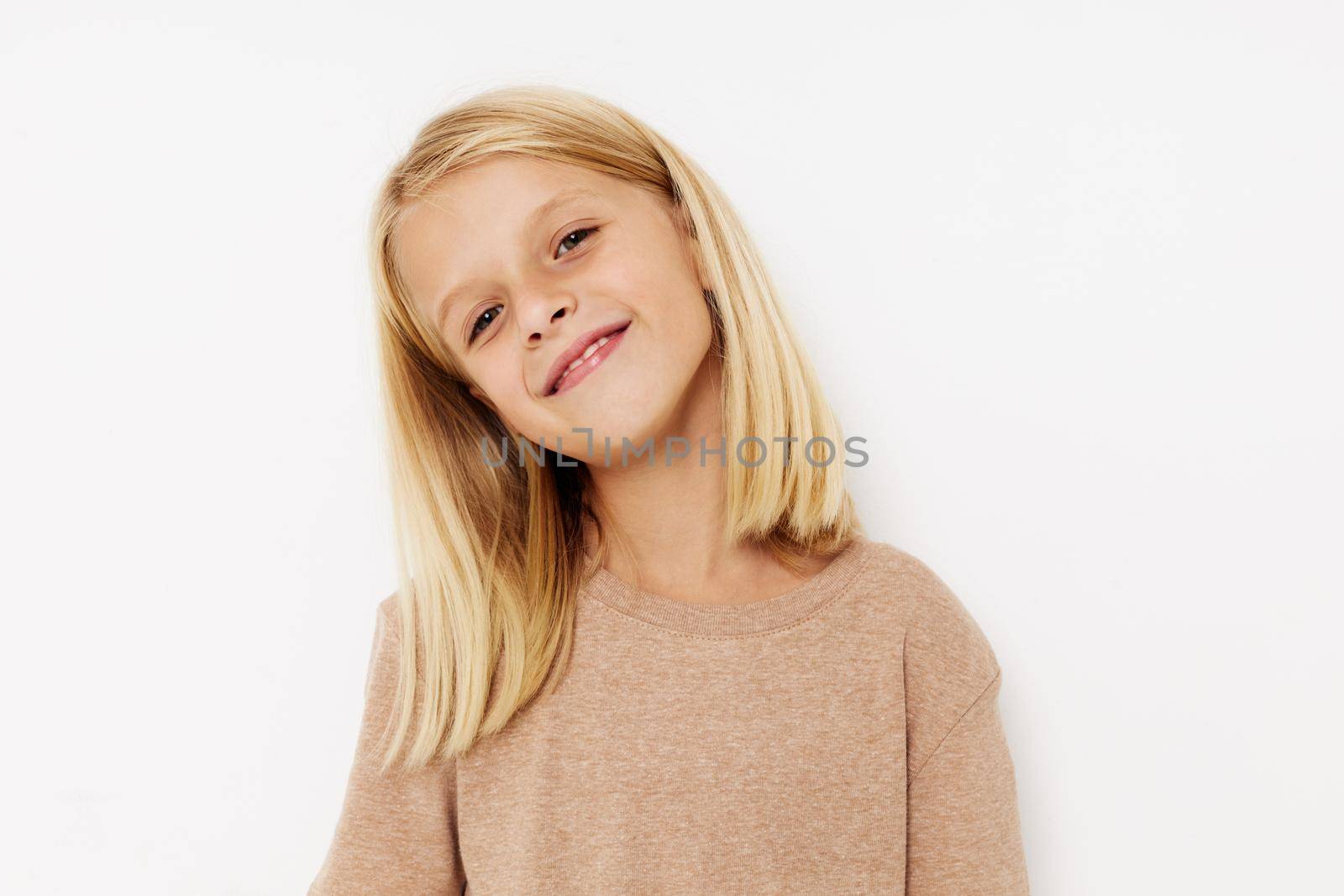 Positive little girl blank space for logo design on a light background. High quality photo