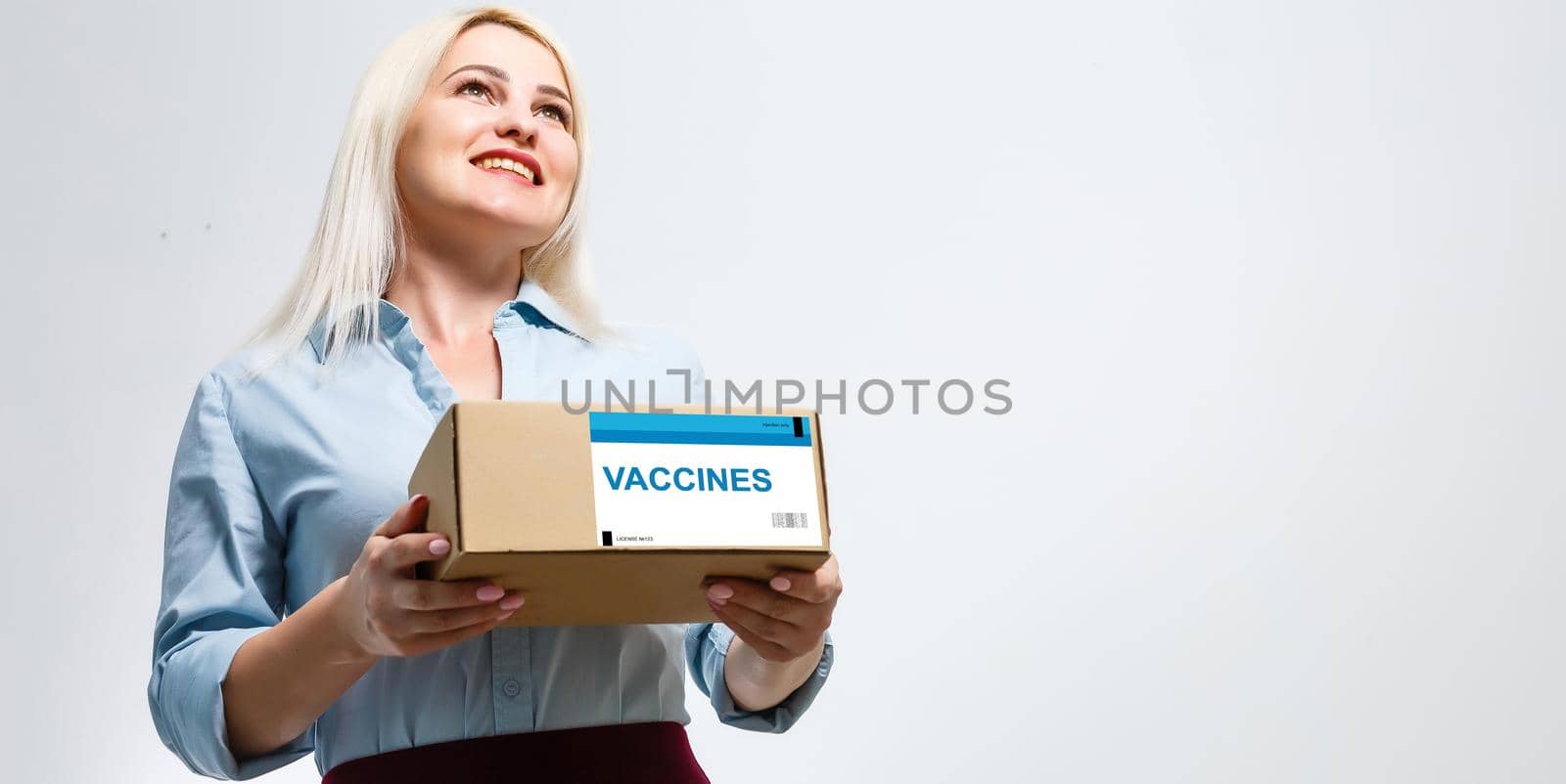 a woman in a mask and puffs delivers a box with a vaccine.