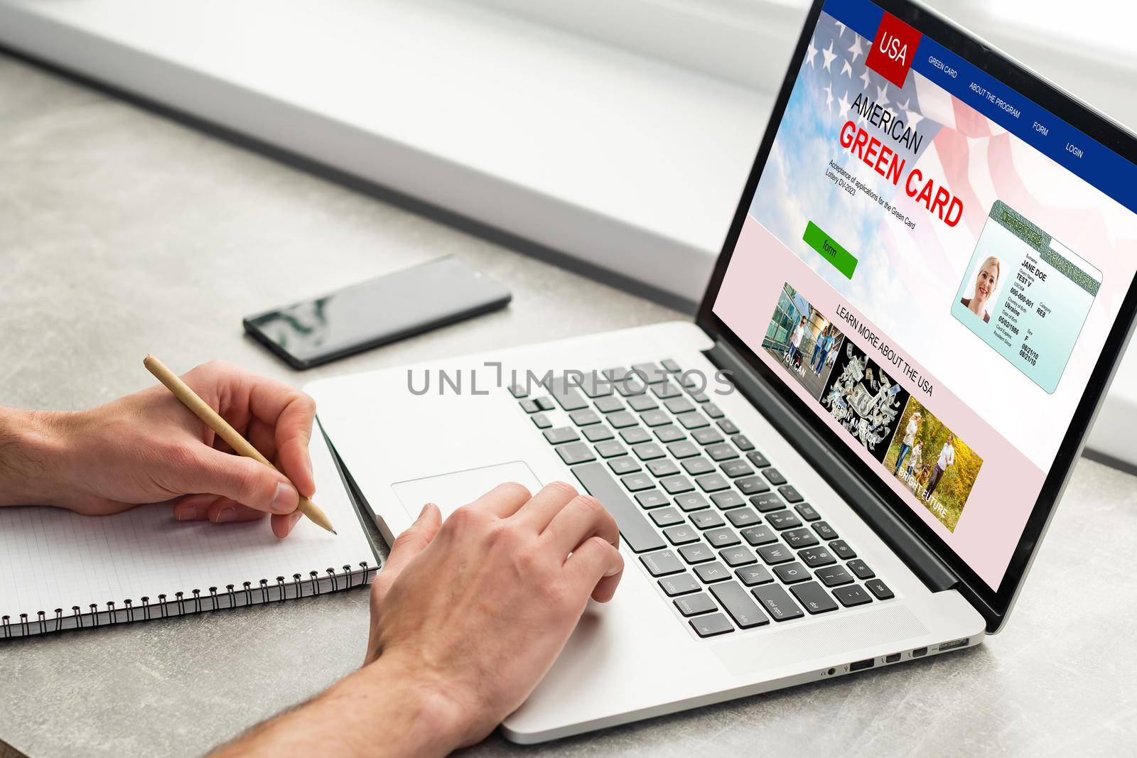 man with laptop with United States Permanent Resident Card website.