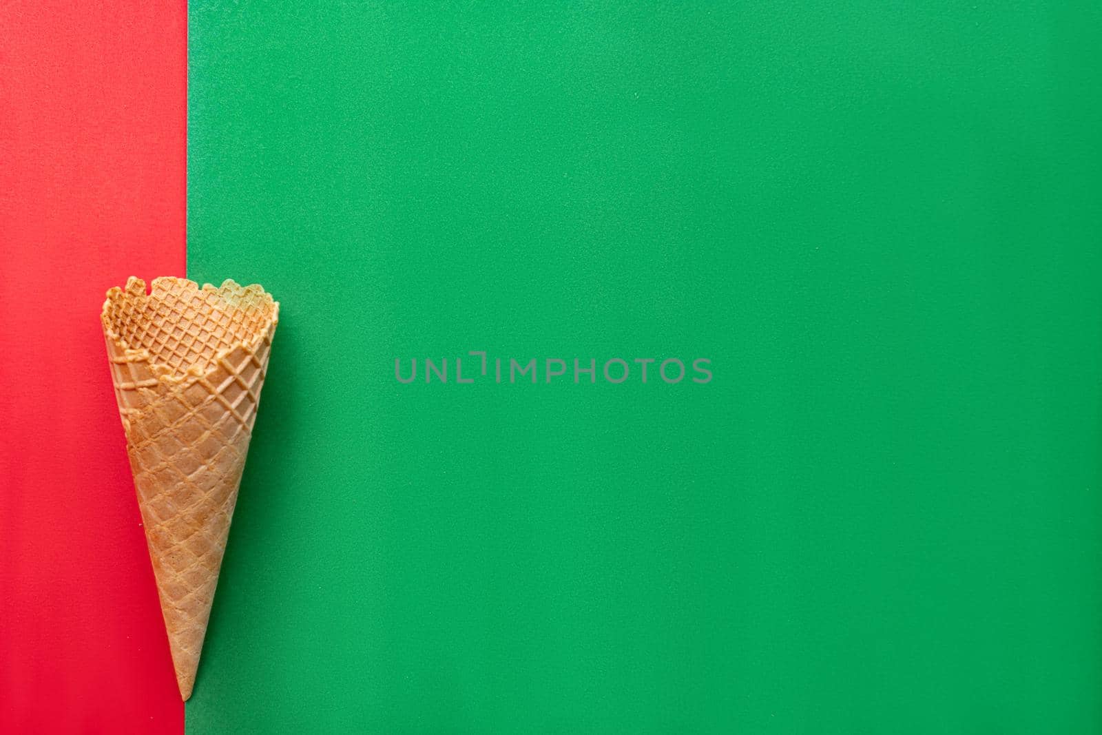 Waffle cone on red and green background by uveita