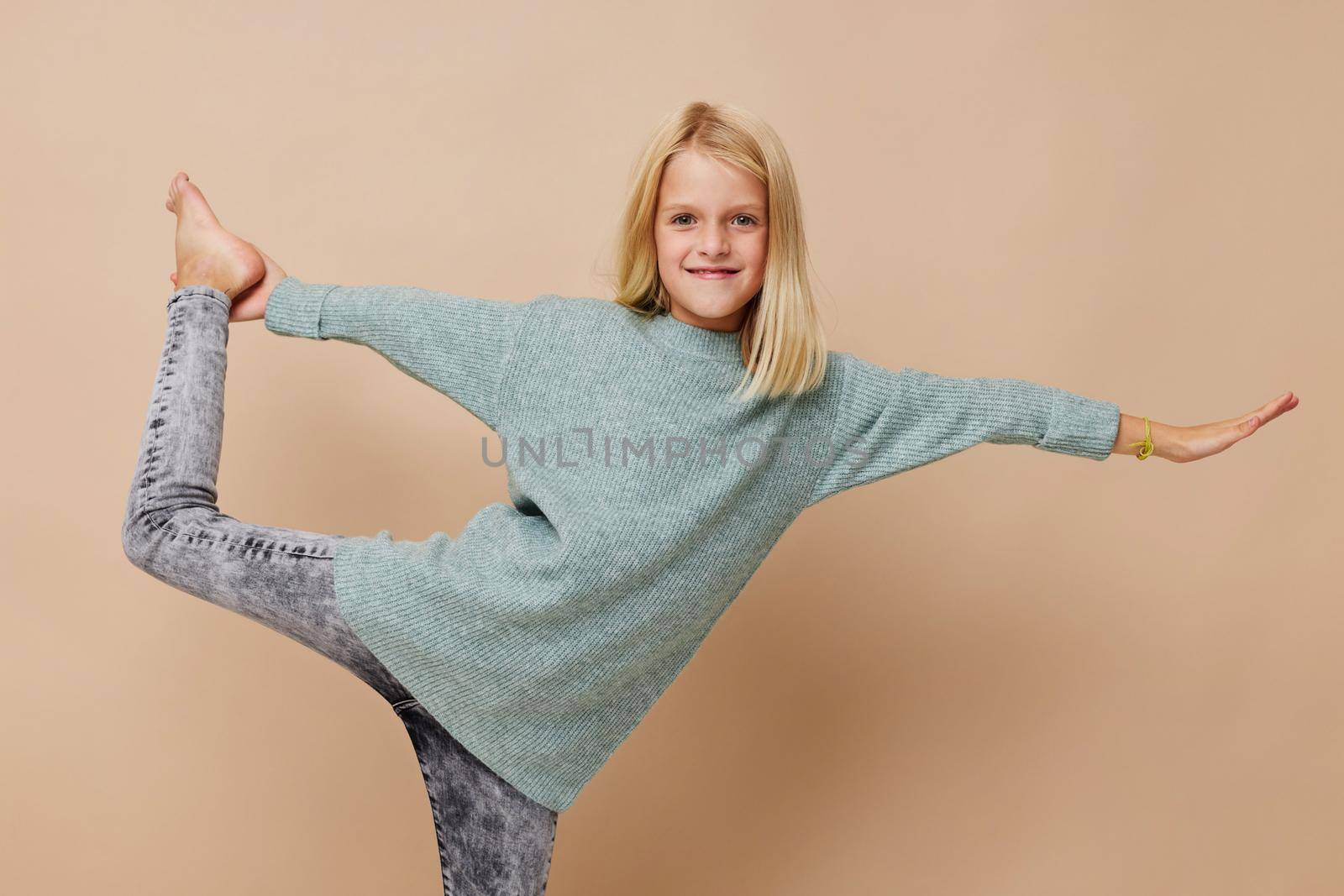 Positive little girl gestures with his hands cropped view. High quality photo