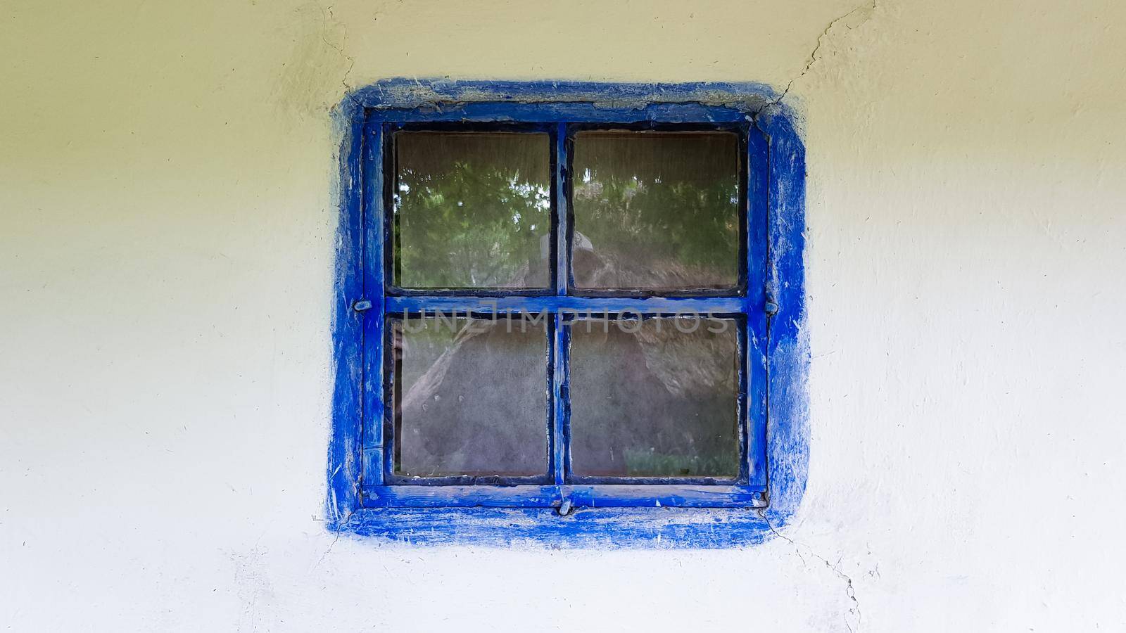 Ukraine, Kiev - June 11, 2020. Old window in a vintage traditional peasant house in Ukraine. Antique wooden window frame. Pirogovo National Museum in the open air in Kiev. Copy space