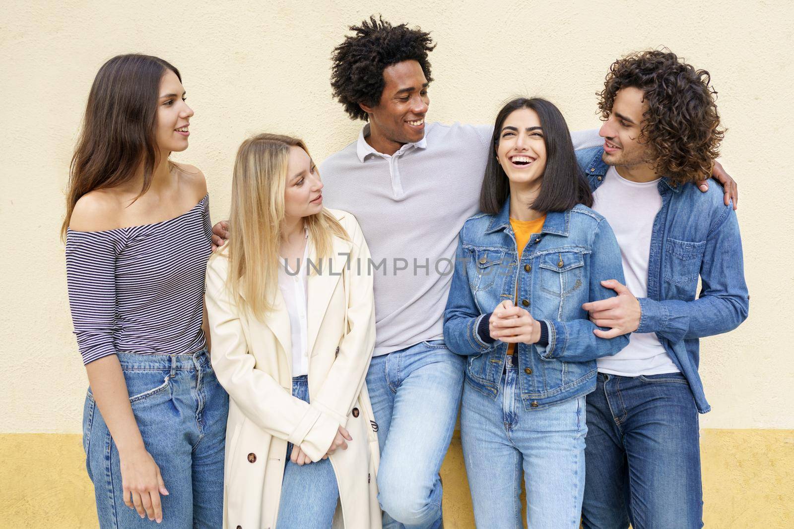 Multi-ethnic group of friends posing while having fun and laughing together by javiindy