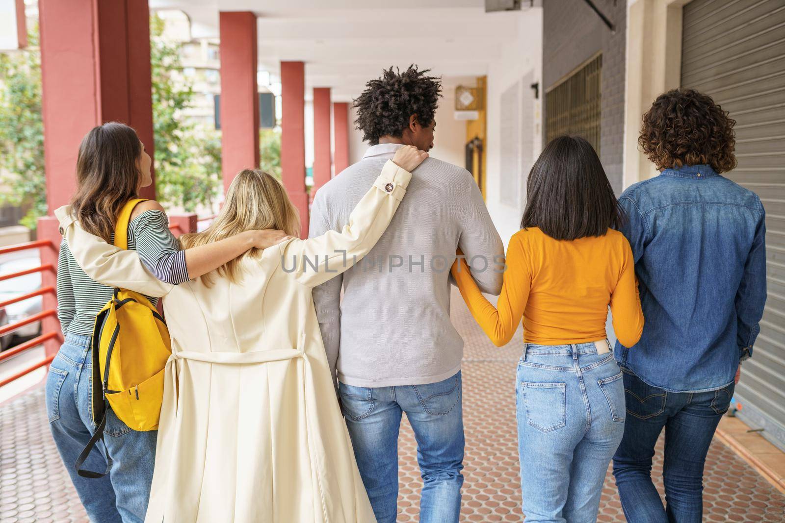 Multi-ethnic group of friends walking together on the street. by javiindy