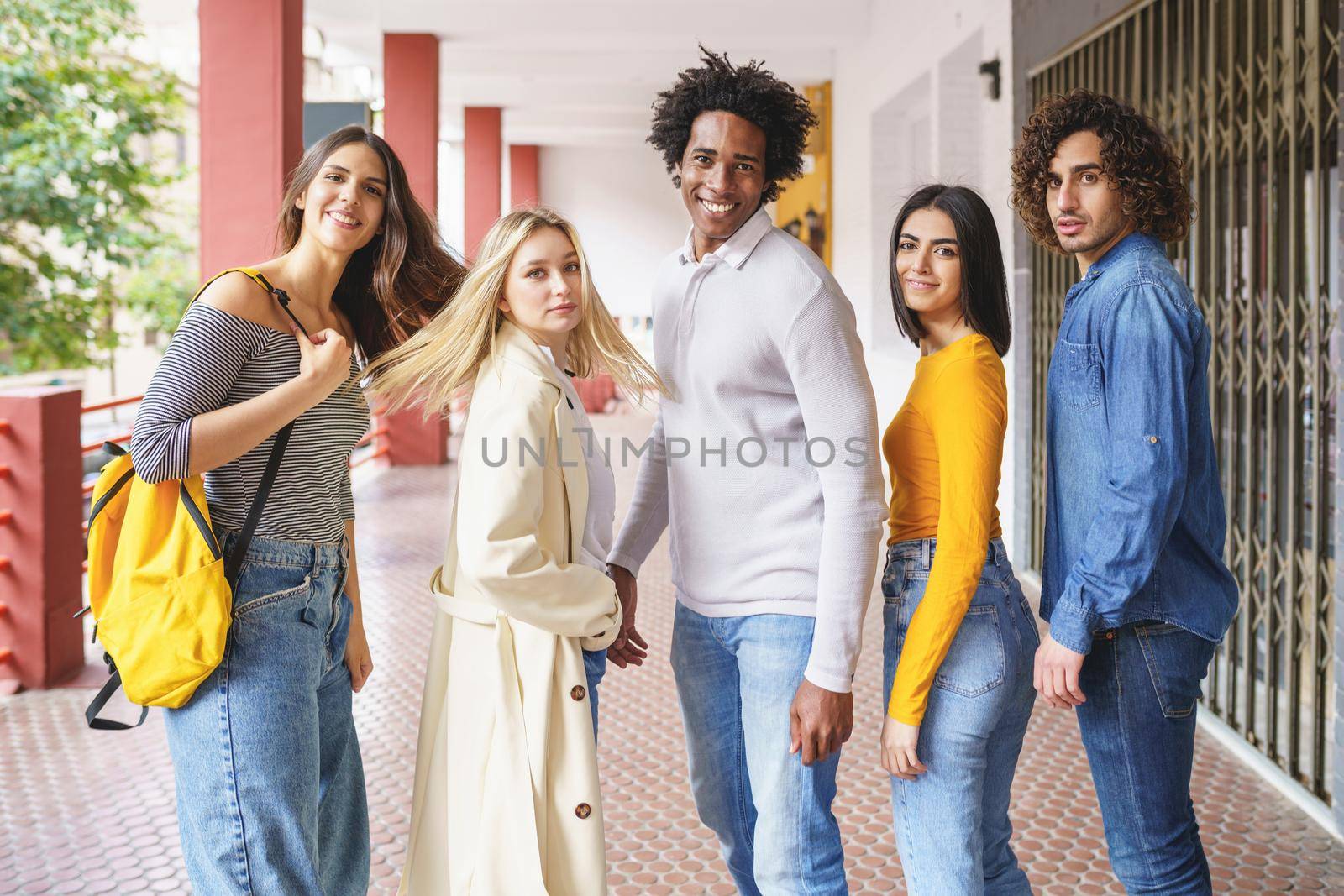 Group of beautiful friends of different ethnic having fun together in the street. by javiindy