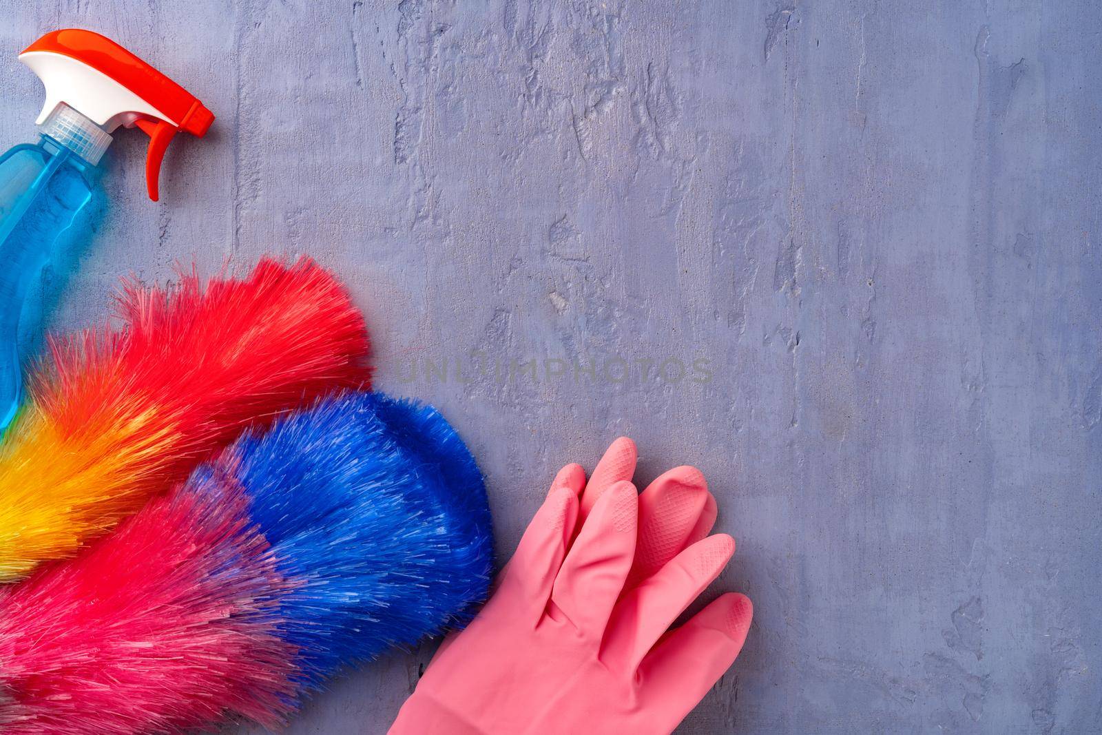 Cleaning supplies for household flatlay on gray background, top view