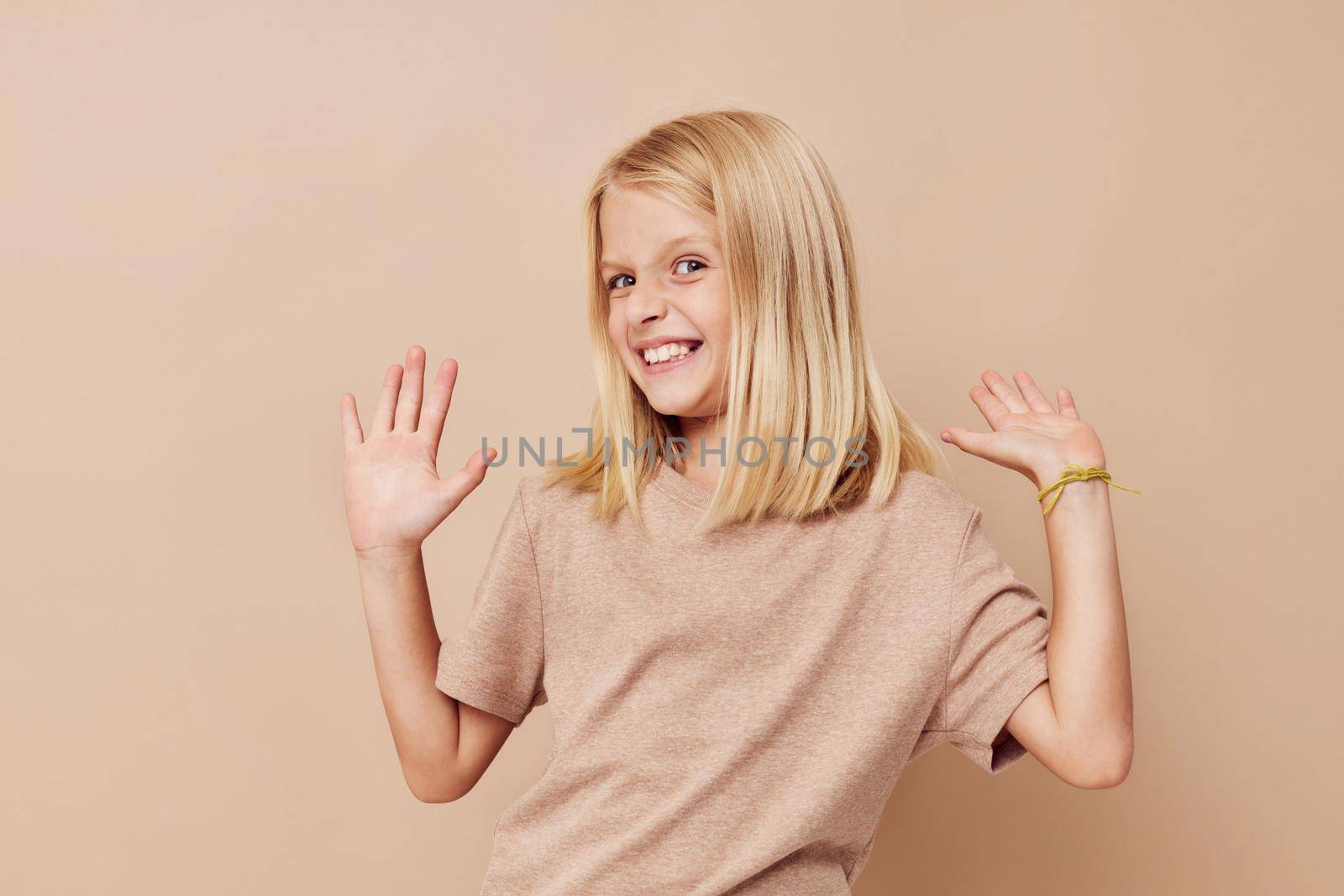 happy cute girl gestures with his hands isolated background. High quality photo