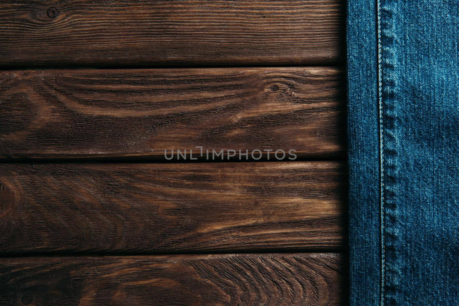 Blue jeans on wooden background. by alexAleksei