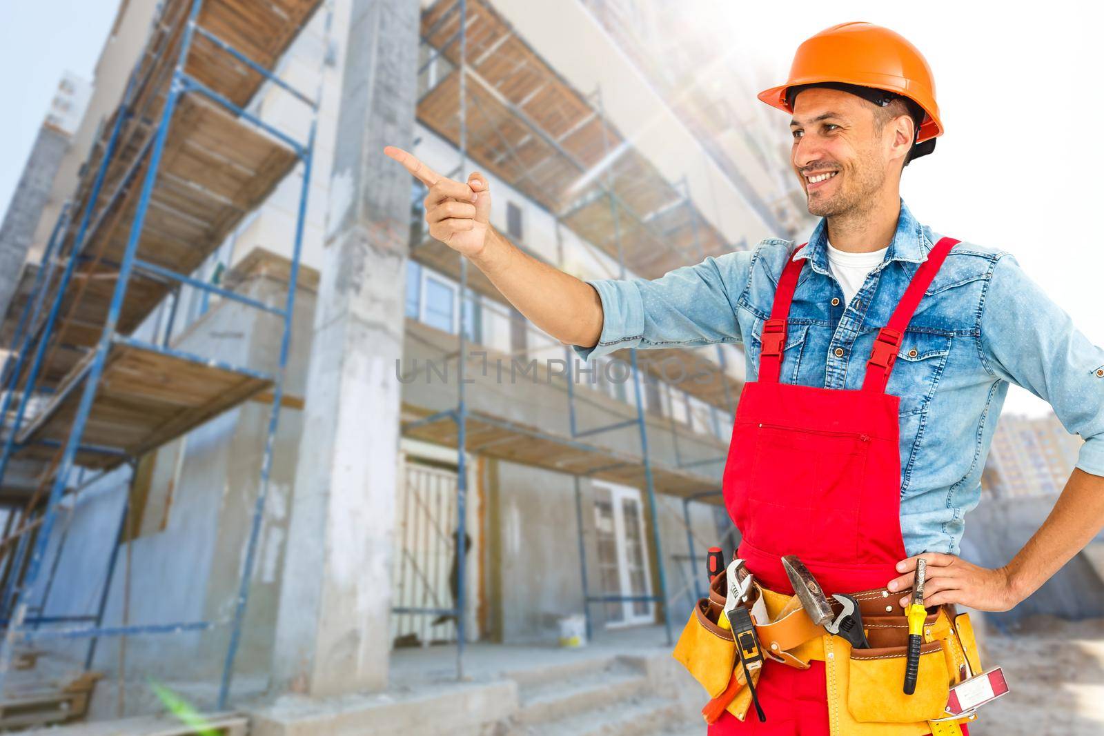 Worker with a diy tool belt over construction background