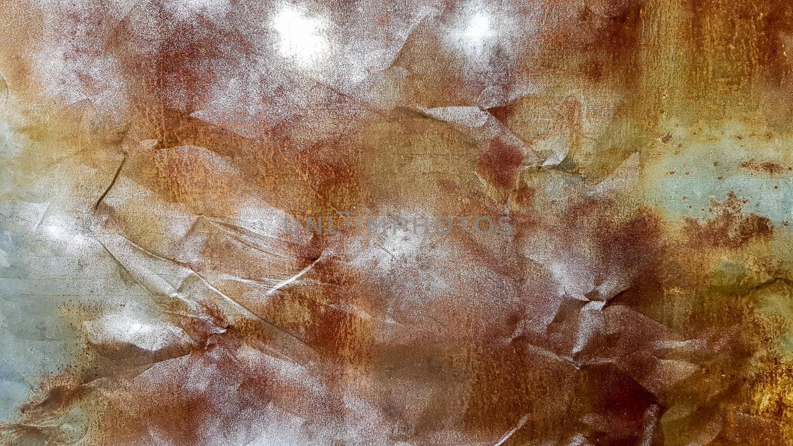 Seamless texture of old crumpled and rusty metal. A crumpled metal plate. Rusty grunge background of peeling paint. Close-up. For design, copy space.