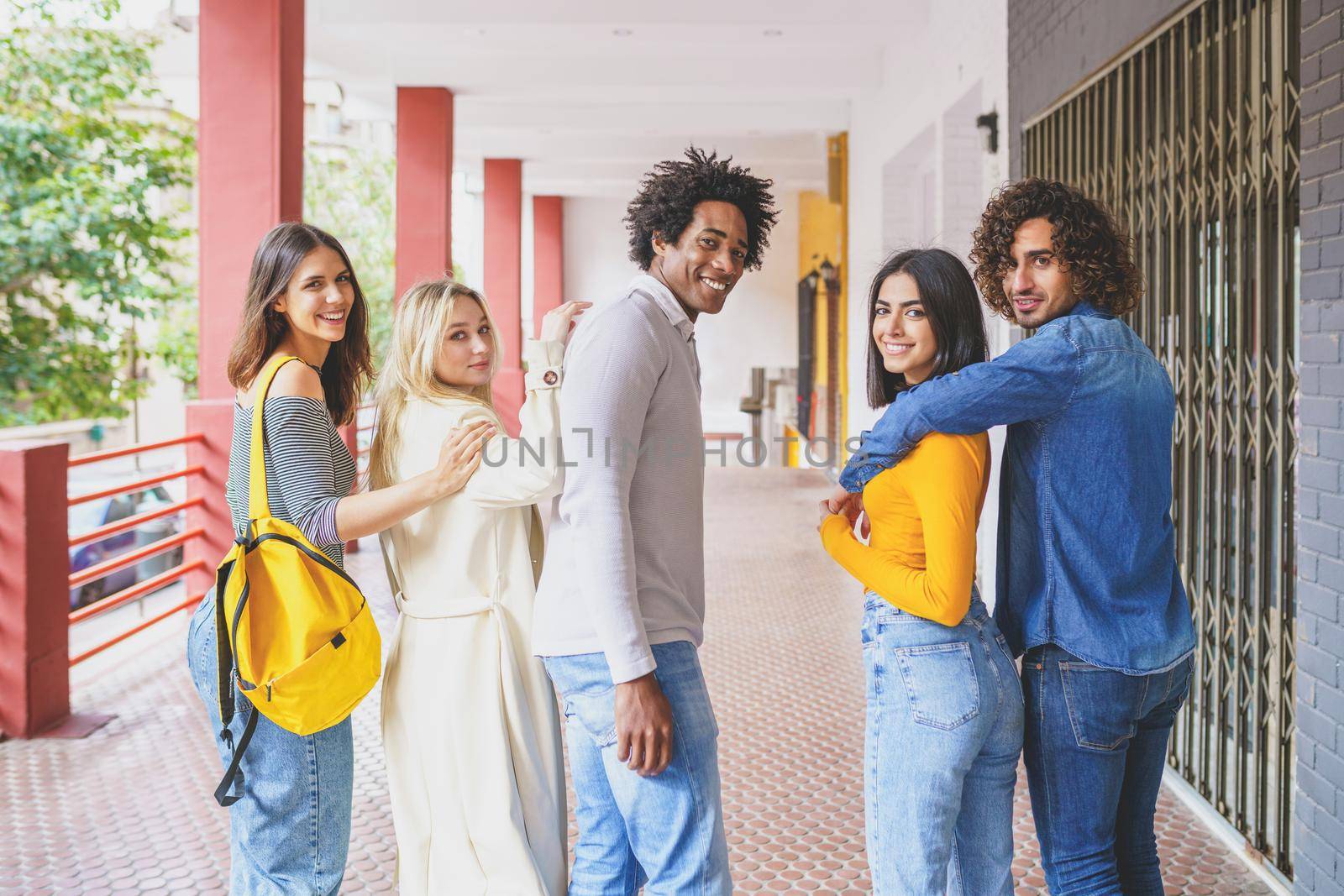 Group of beautiful friends of different ethnic having fun together in the street. Young people having fun together.