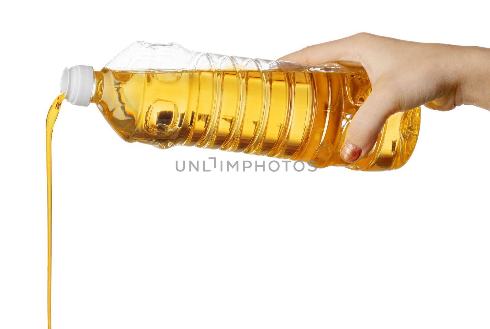 Hand of woman pouring cooking oil from plastic bottle. Isolated on white background. Close up.