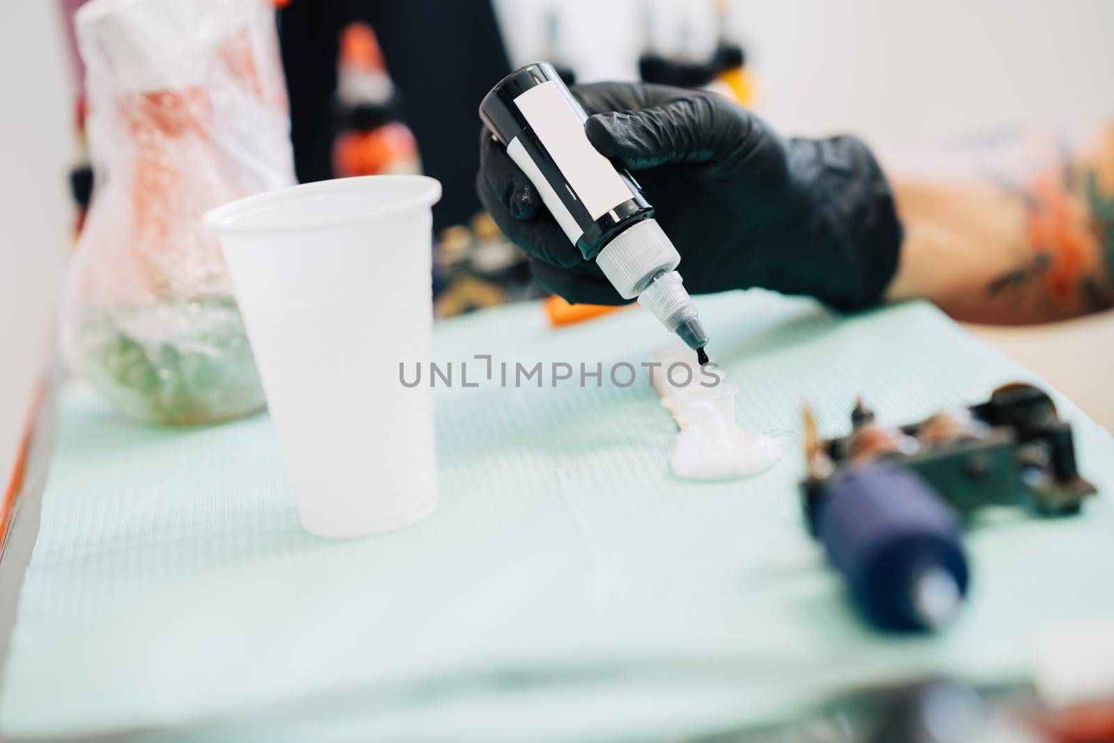 Female tattooist preparing the dyes she's going to work with. by javiindy