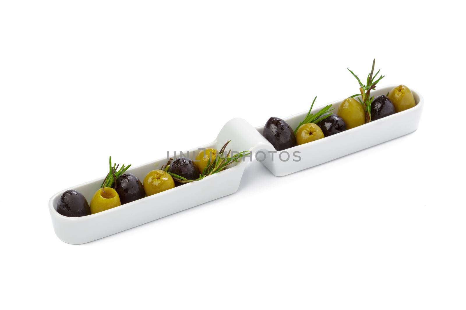Black and green olives served in white plate isolated on white background