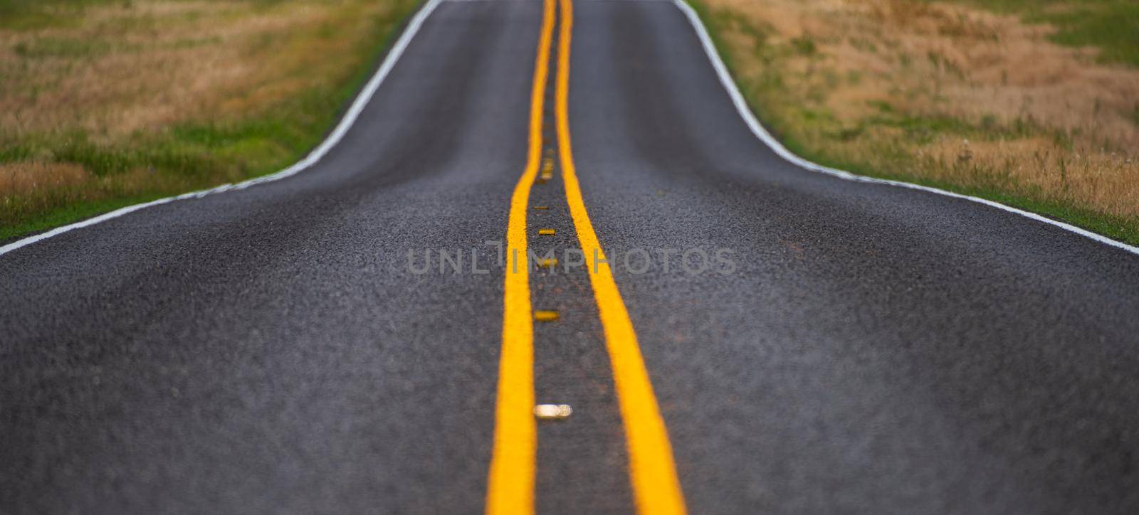 Asphalt texture, way background. Natural american landscape with asphalt road to horizon. by Tverdokhlib