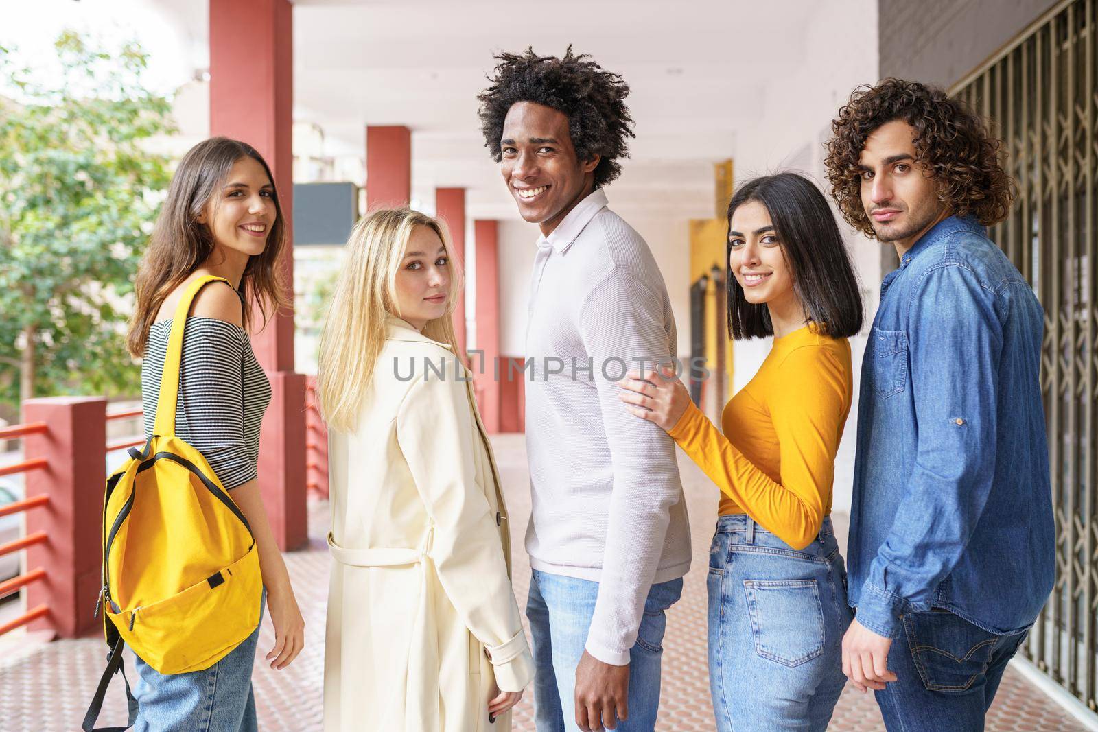 Group of beautiful friends of different ethnic having fun together in the street. by javiindy