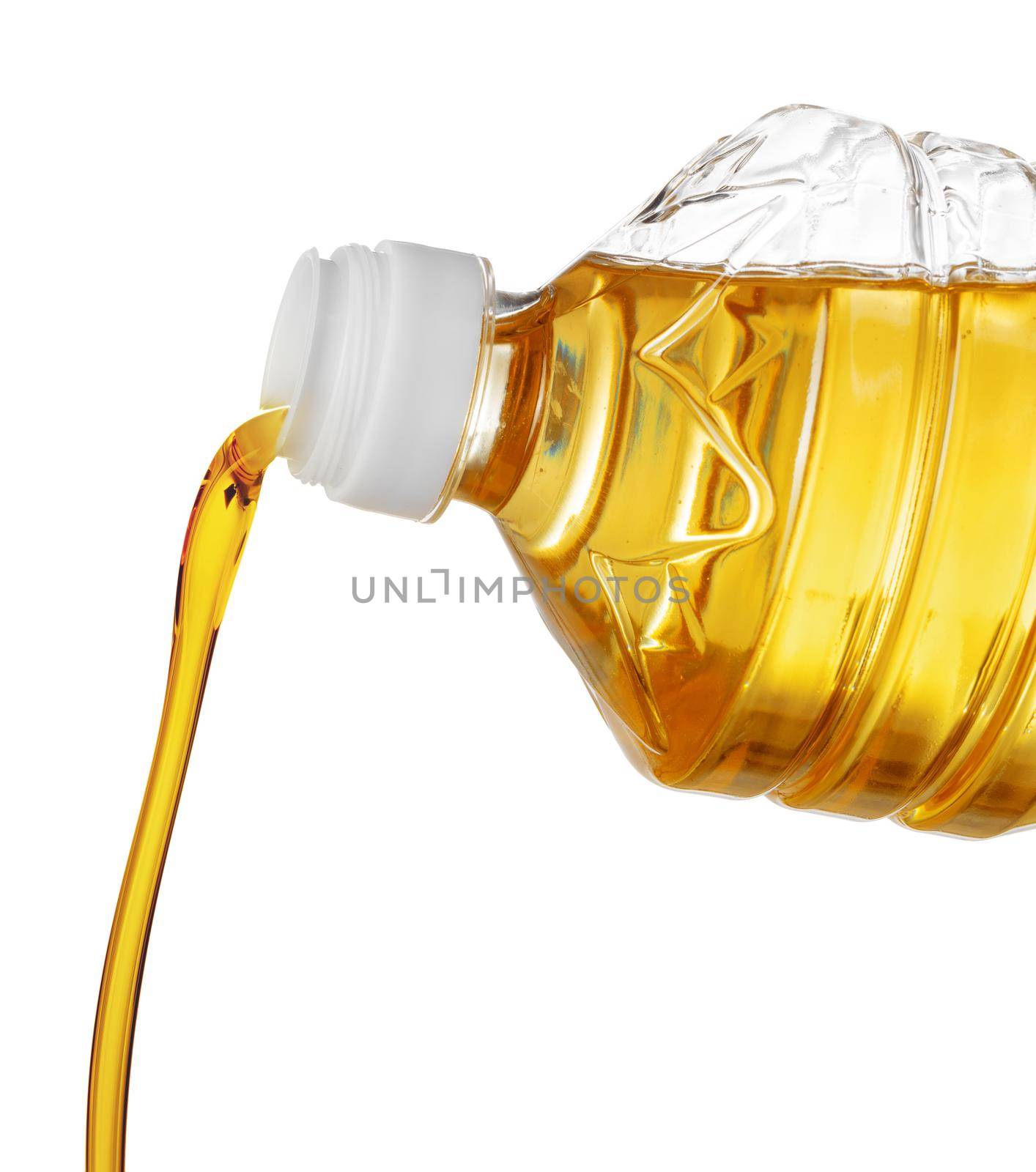 Pouring oil for cooking in a bottle isolated on white background. Close up.