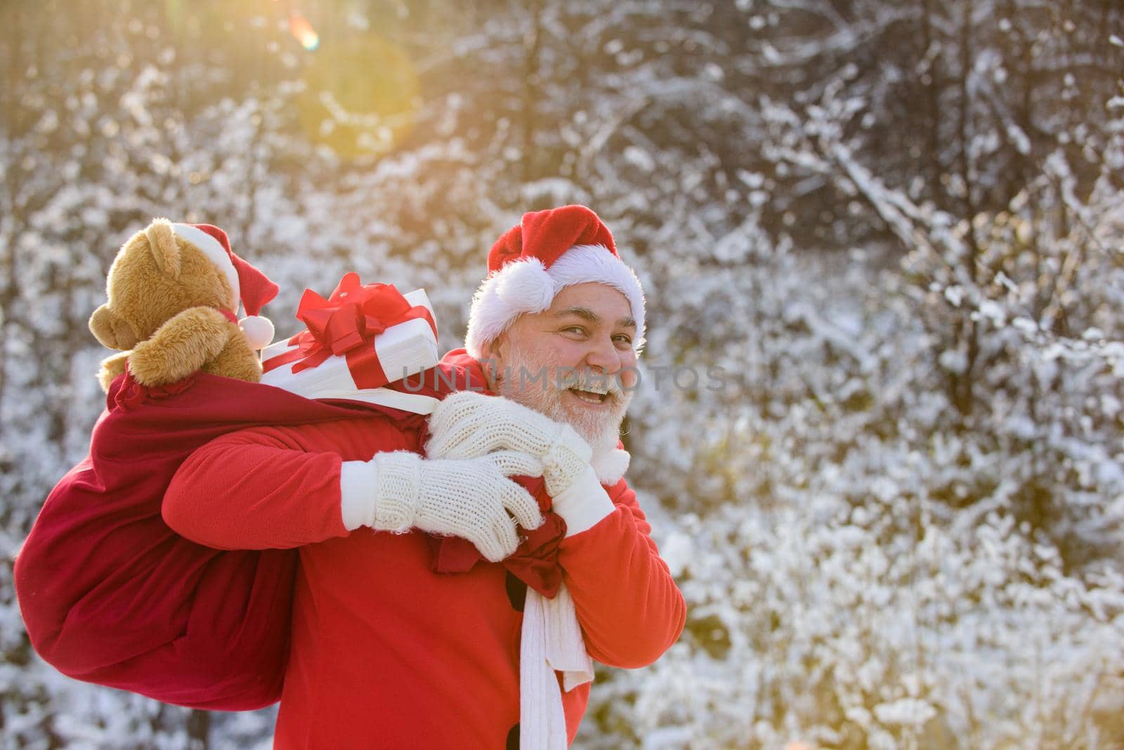 Santa grandfather deliver gifts. Santa Claus in snowy winter mountain. New Year and xmas is coming