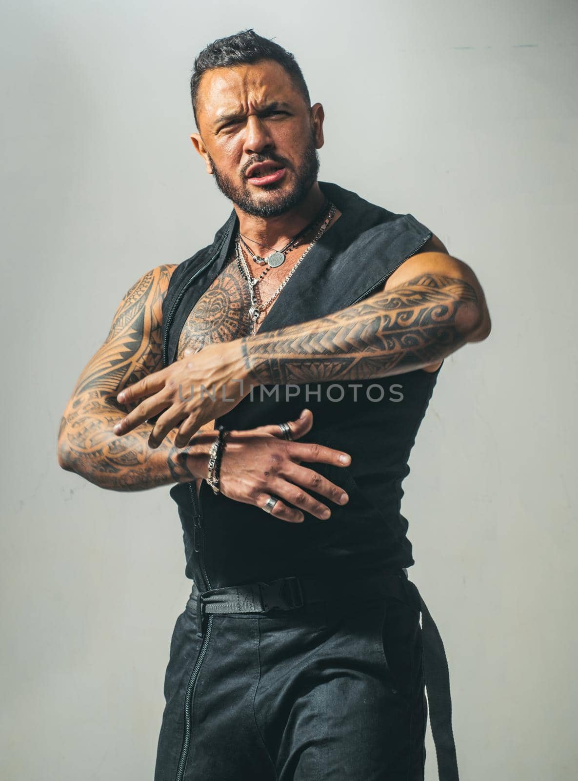 Studio shot of young man looking at the camera. Handsome guy with confident face