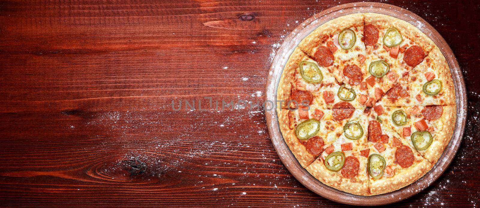 fresh american pizza on wooden table with space for text